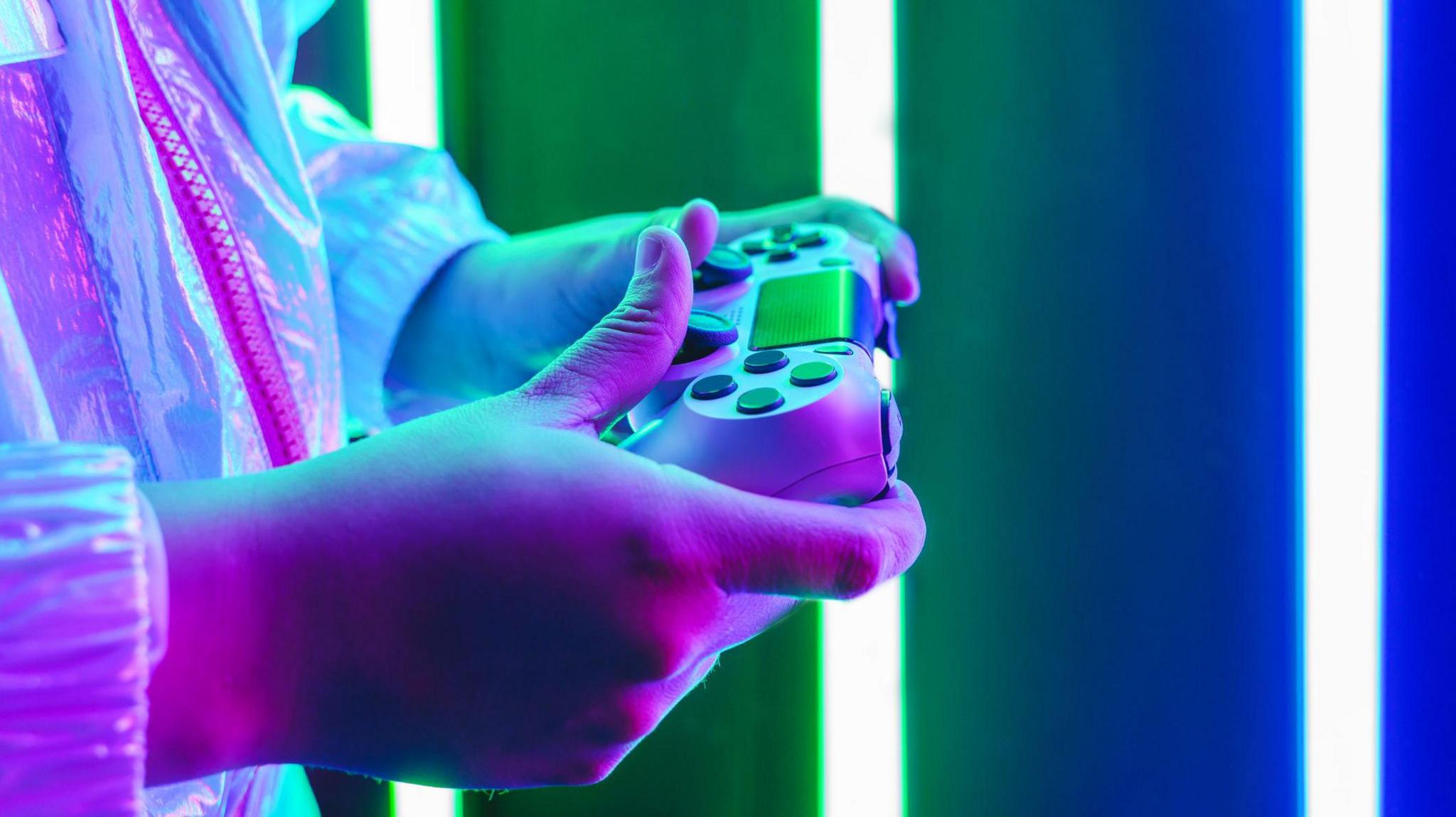 A person holding a games controller.