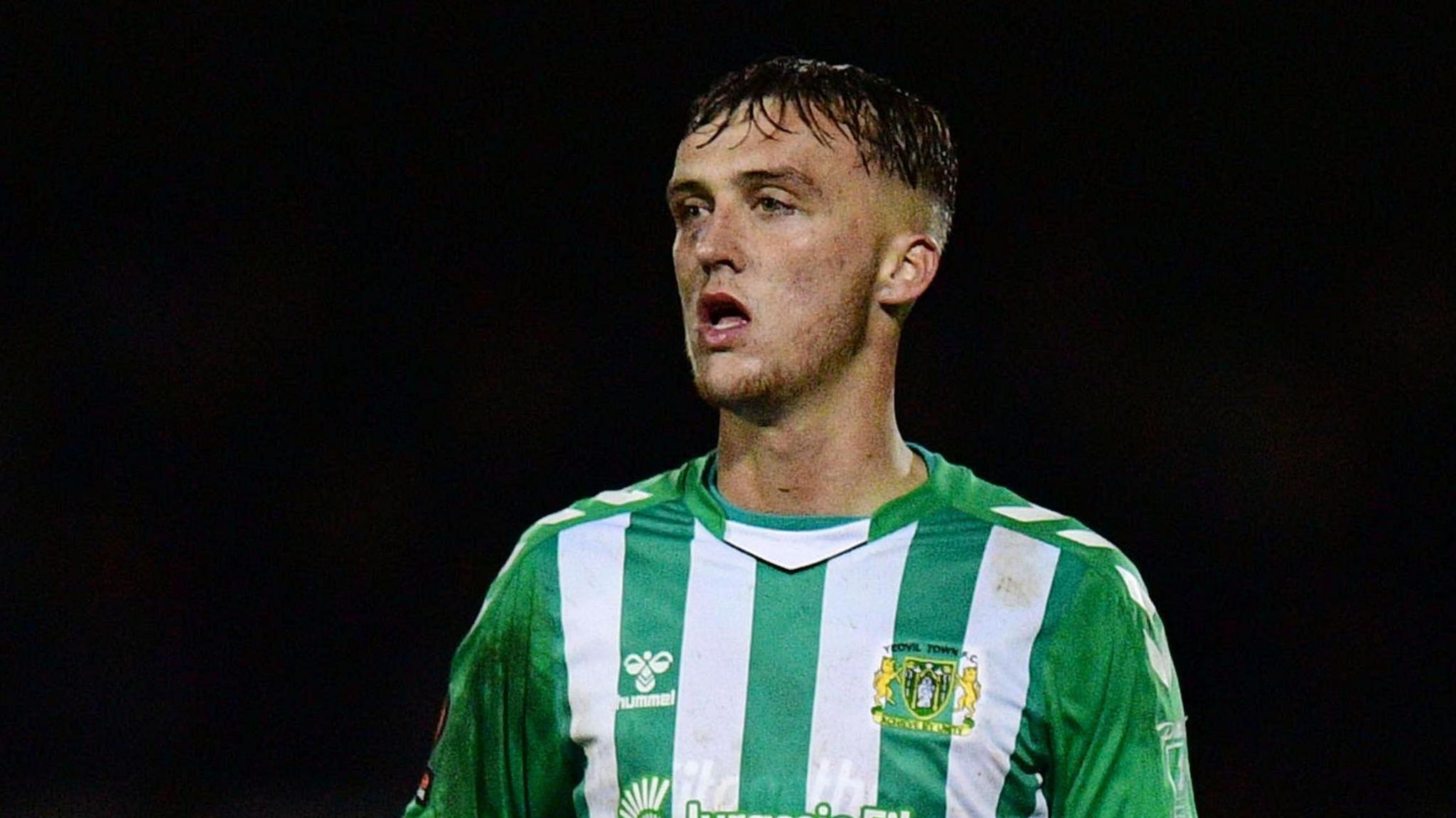 Jamie Andrews in action for Yeovil Town. He is wearing a green and white striped shirt.