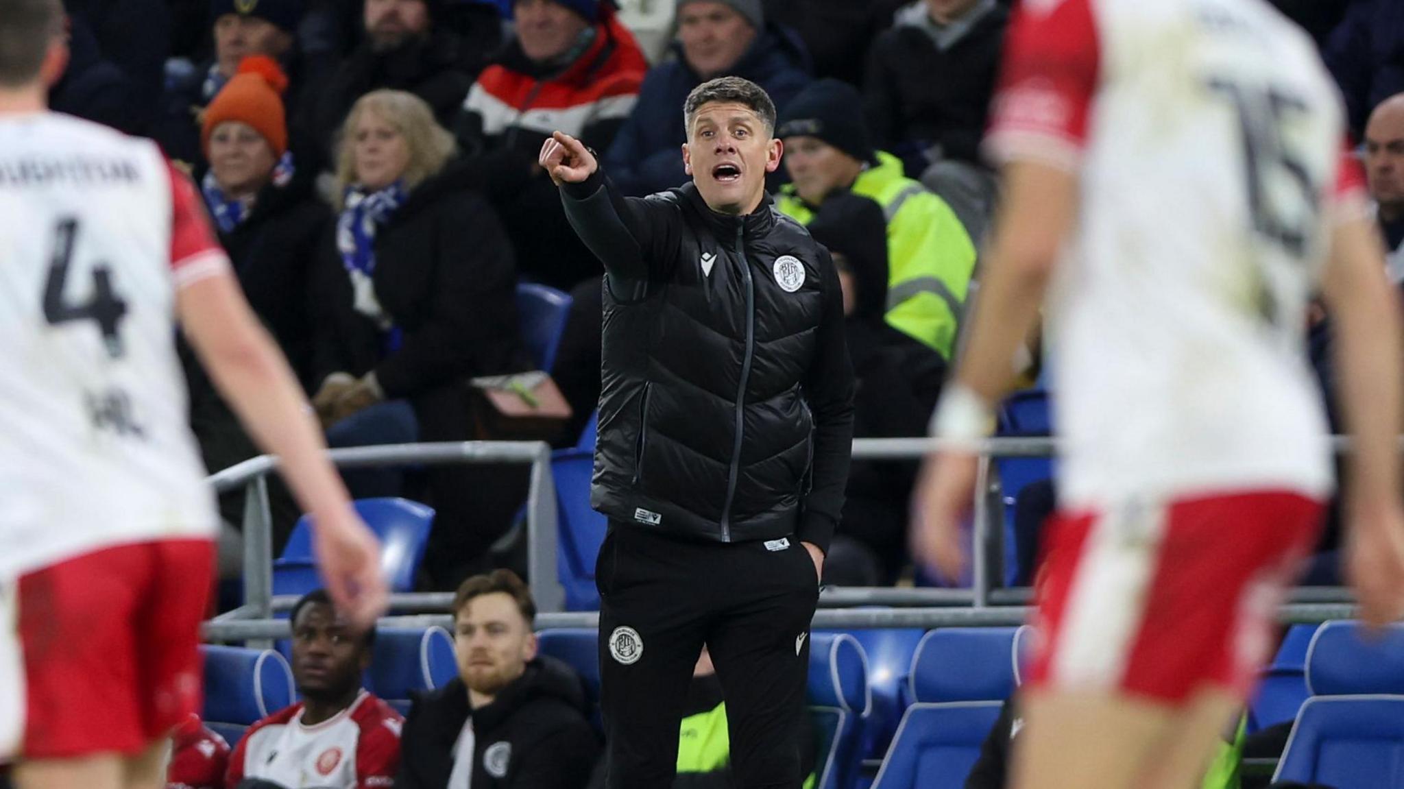 Alex Revell pointing at his Stevenage players