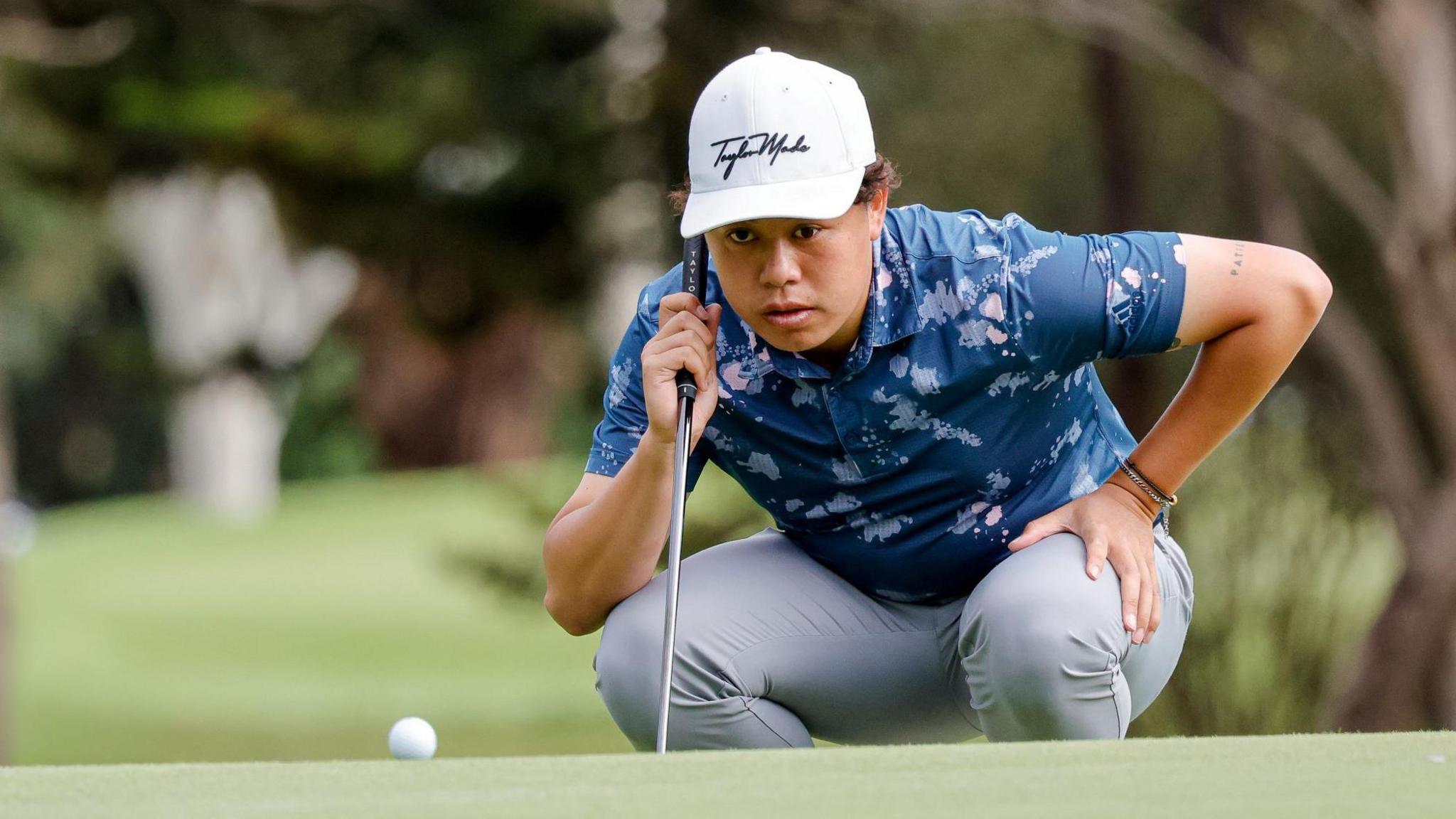 Jeffrey Guan lines up a putt