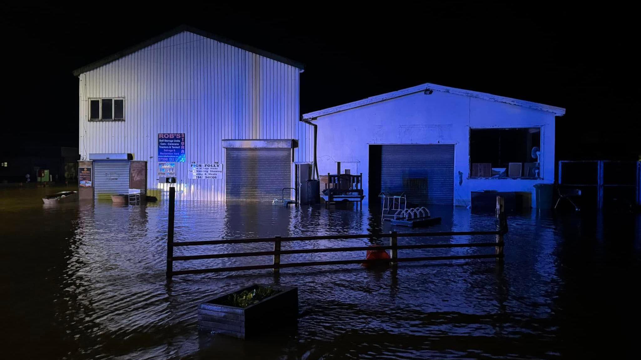 Robbie Laing's furniture shop in Builth Wells, Powys under water during storm Bert