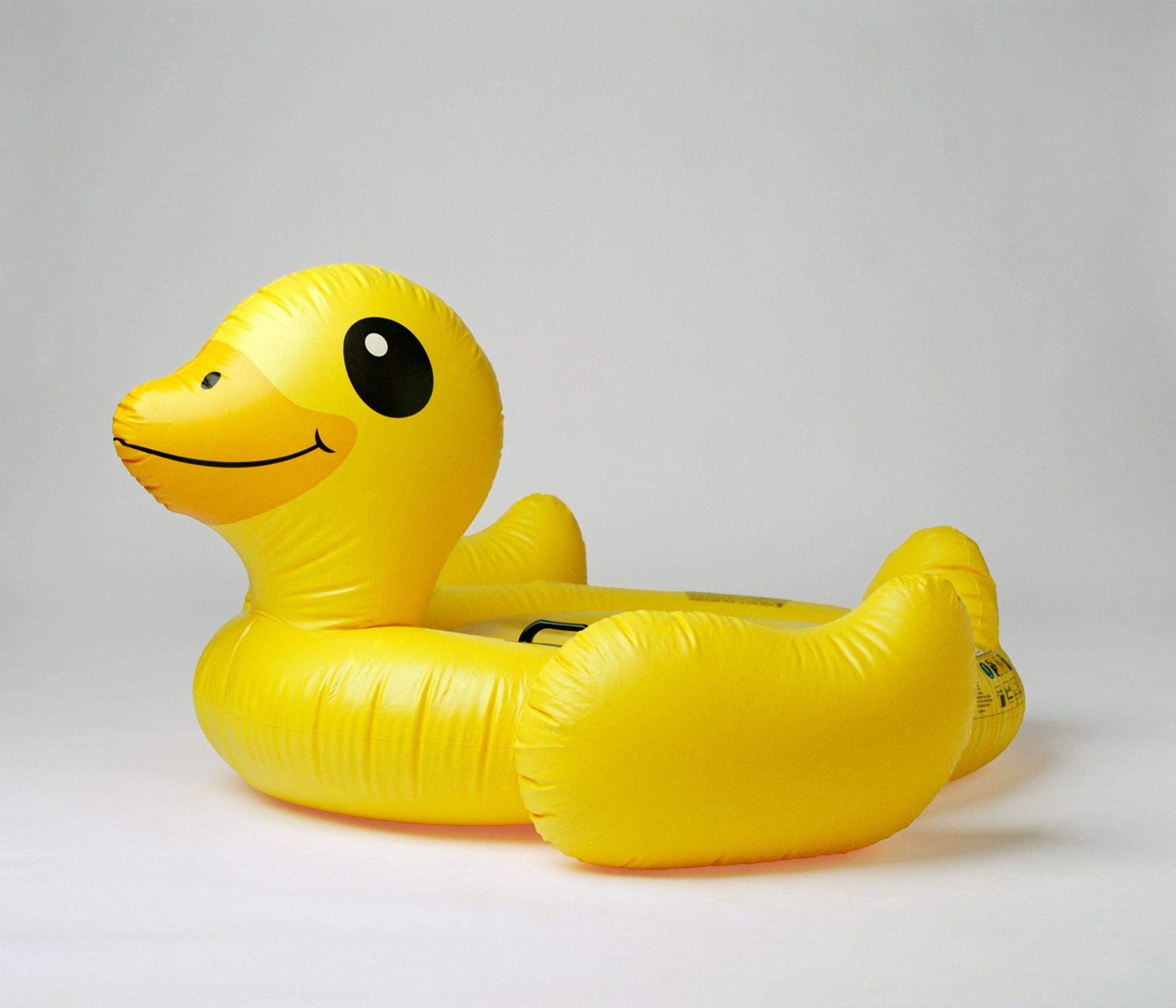 an inflatable yellow duck against a white background 
