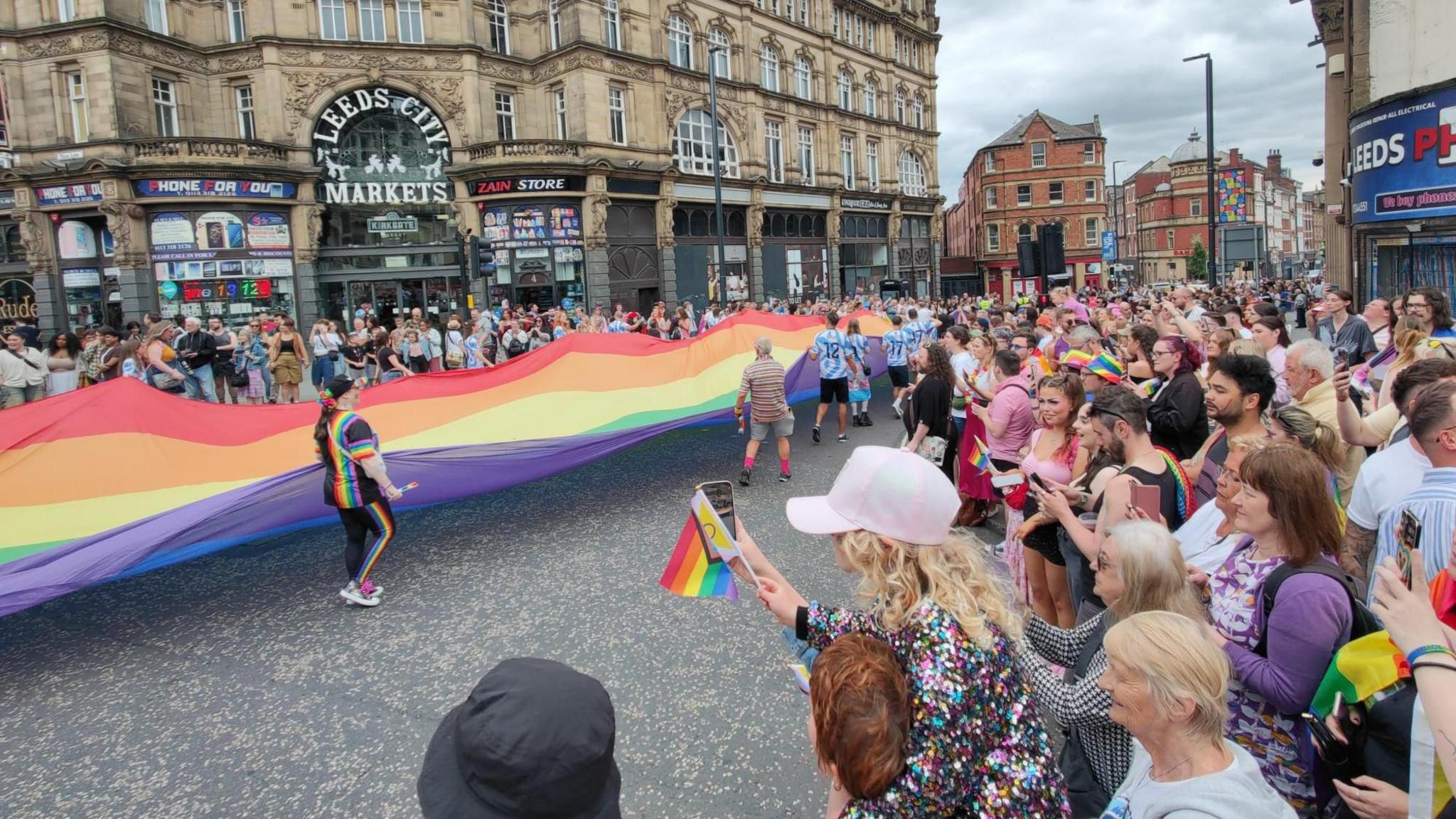 A large rainbow flag outside Leeds City Markets