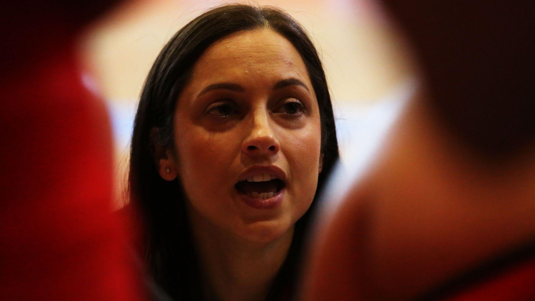 Emily Handyside speaks inside a player's huddle