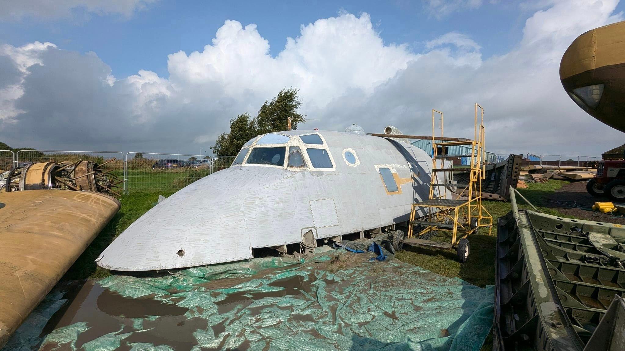 The top section of the plane is grey - as all the paint has been stripped off.