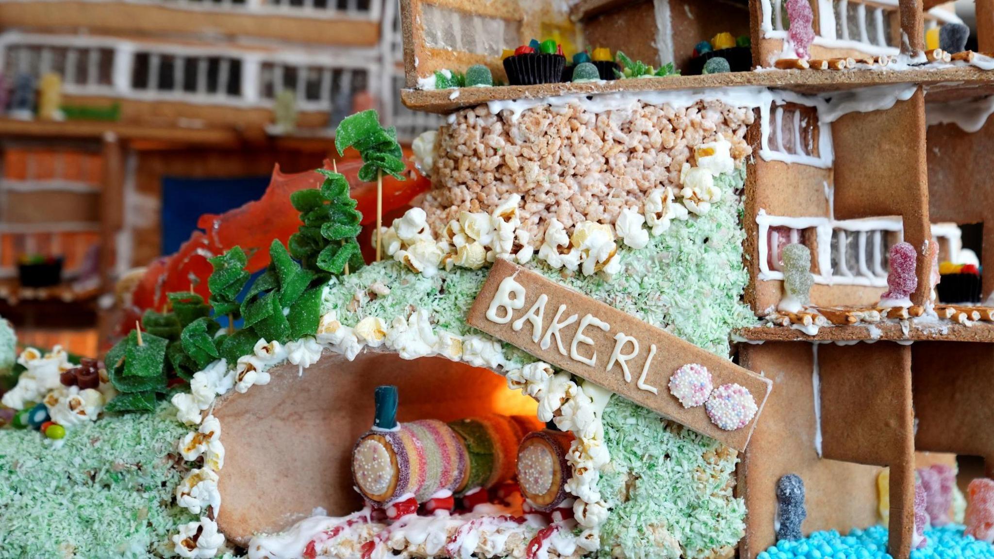 A gingerbread train in a gingerbread tunnel. It has a sign saying Bakerloo, with the "oo" made from two round sweets.