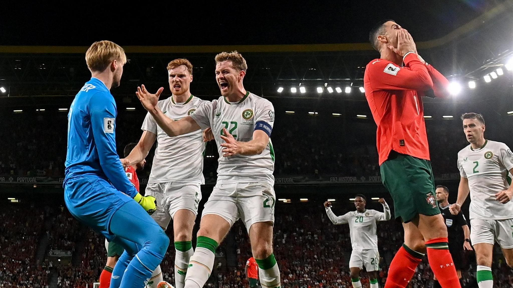 Caoimhin Kelleher celebrates his penalty save from Cristiano Ronaldo 