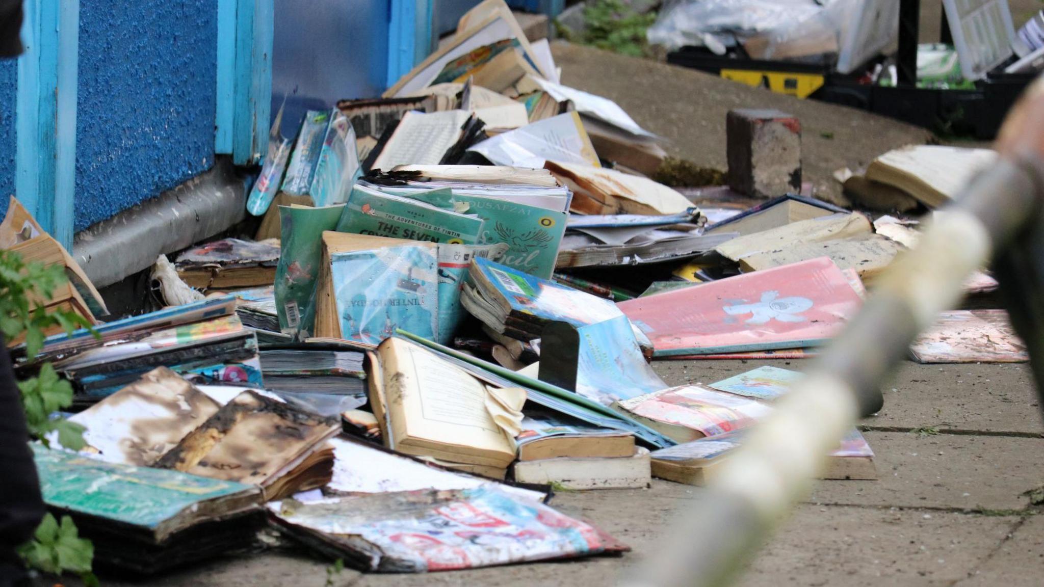 Burnt books piled up on the floor