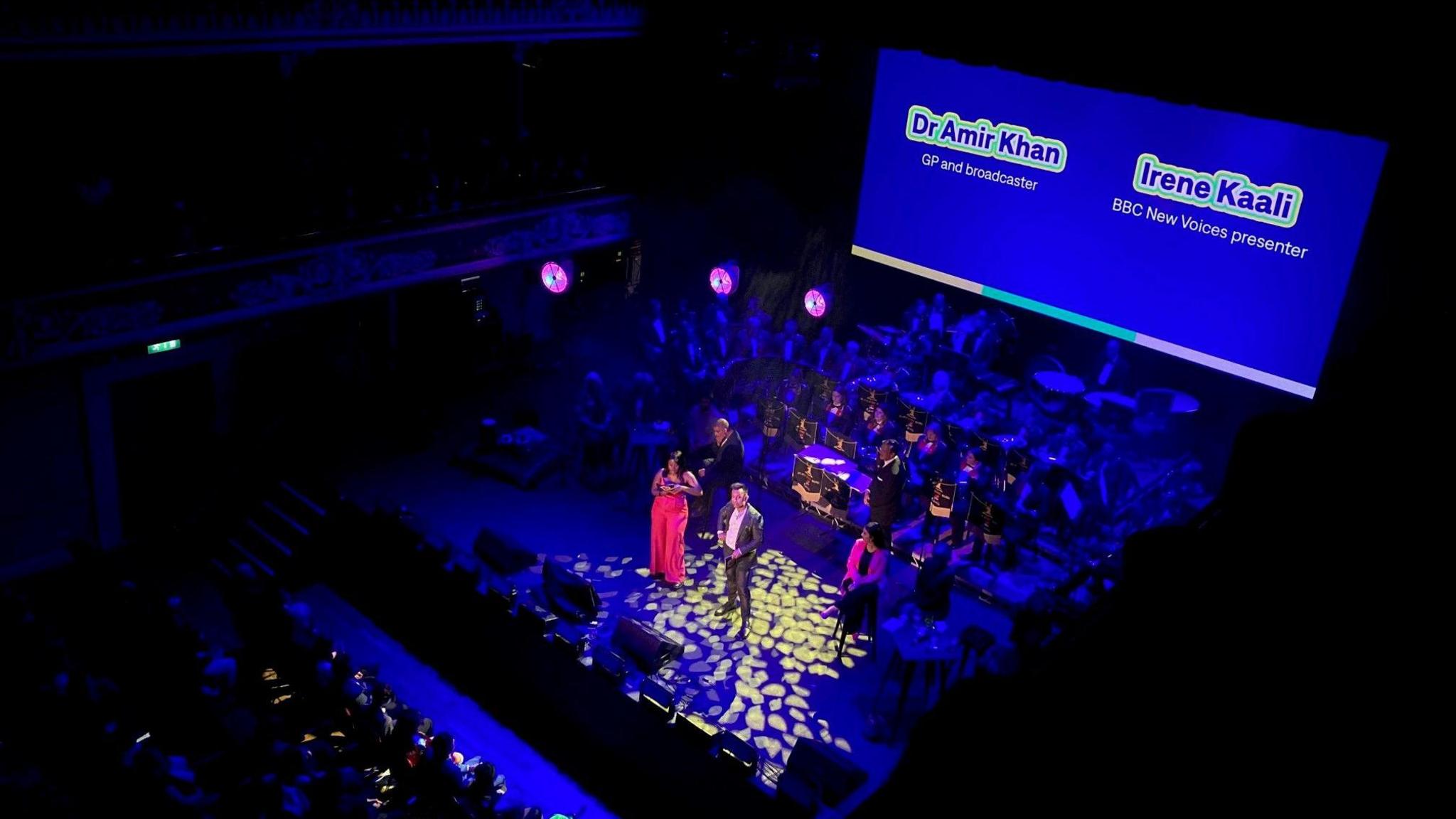 BBC New Voices presenter Irene Kaali and Dr Amir Khan on stage in St George's Hall