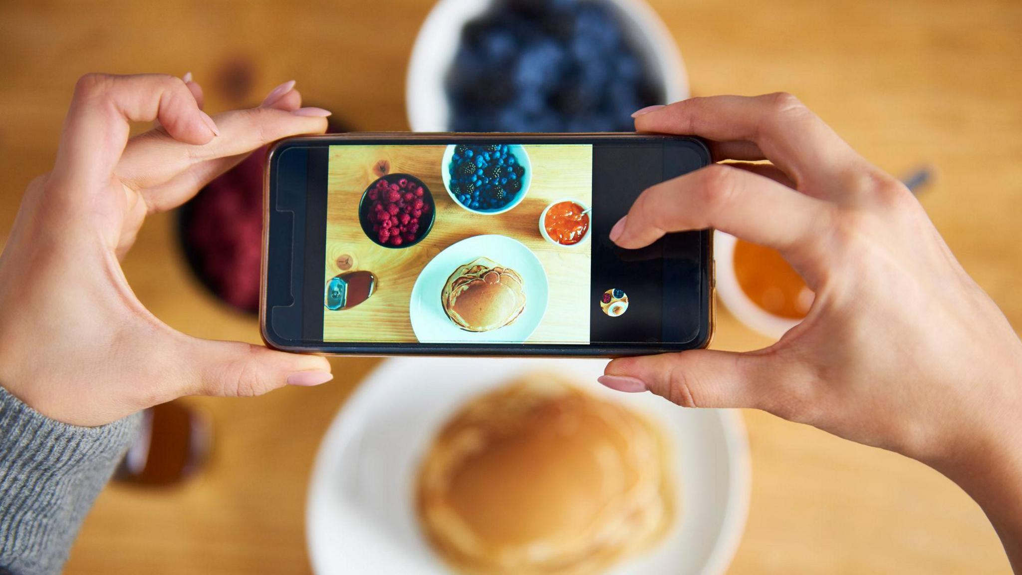 food photographer taking photo of pancakes