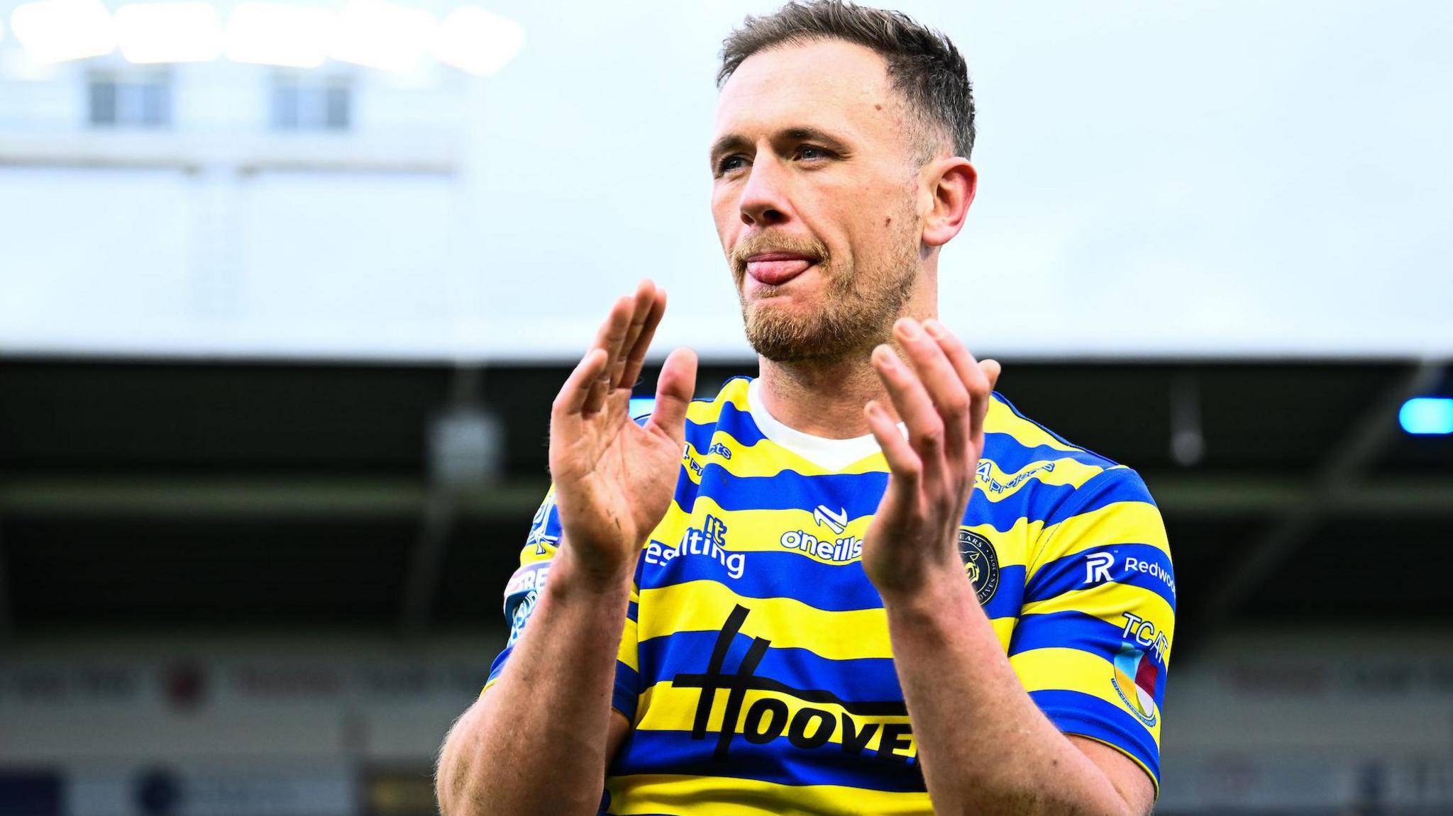 Warrington Wolves' Ben Currie applauds the fans after a match against Leigh Leopards