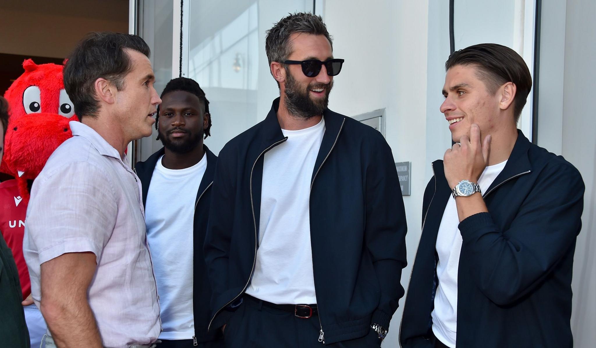 George Dobson (right) chats with Wrexham co-owner Rob McElhenney as Ollie Palmer (centre) looks on during the club's North America tour.