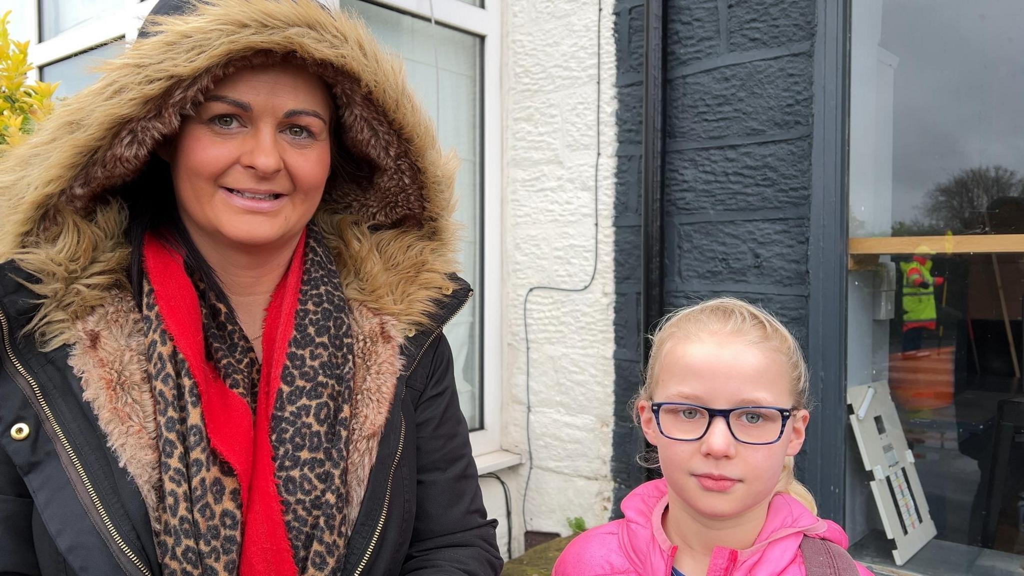 Mum Louise and her daughter Hallie stood outside a shop waiting to cross the road