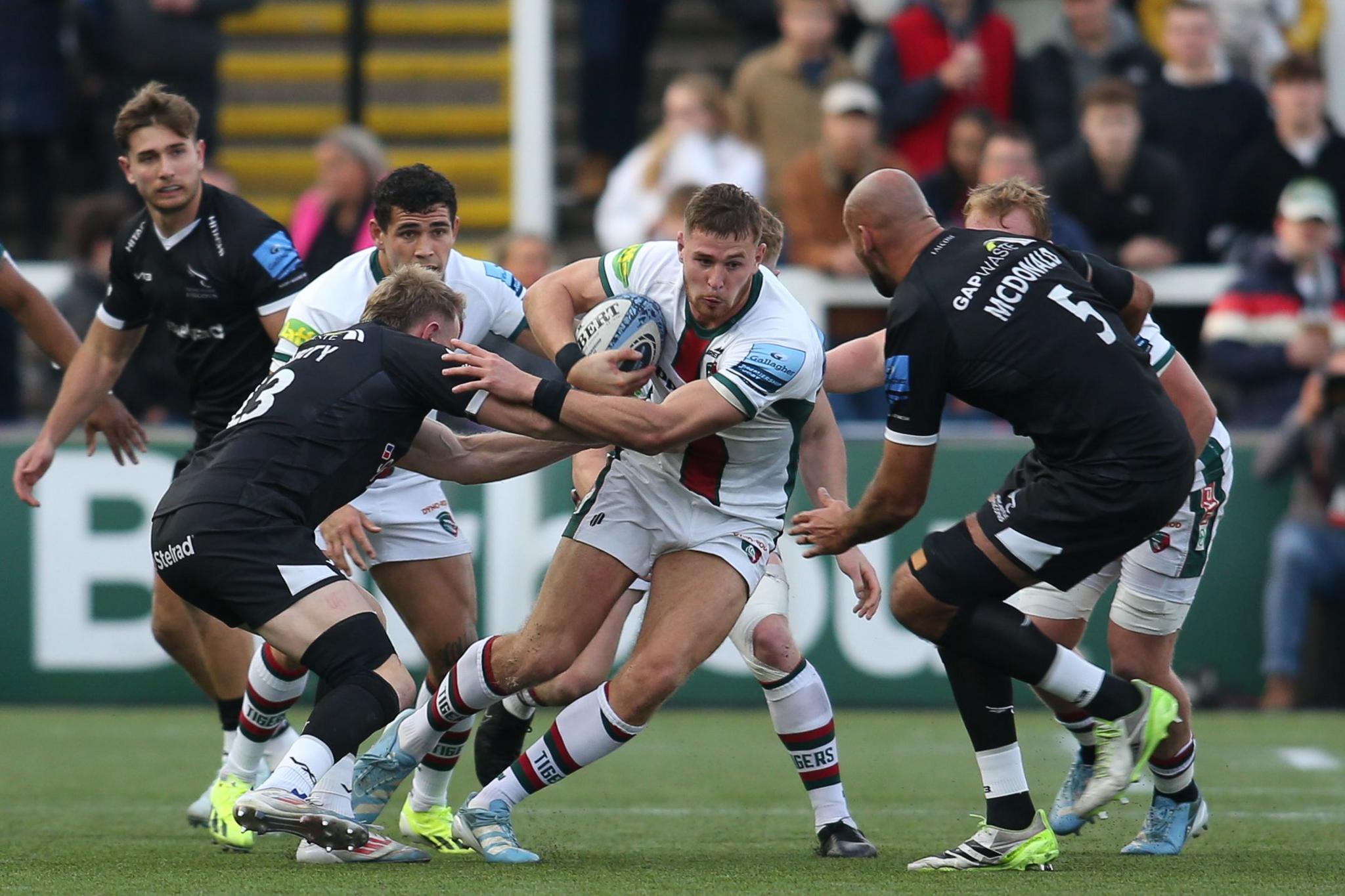 Leicester Tigers full-back Freddie Steward tries to get past Newcastle Falcons defenders