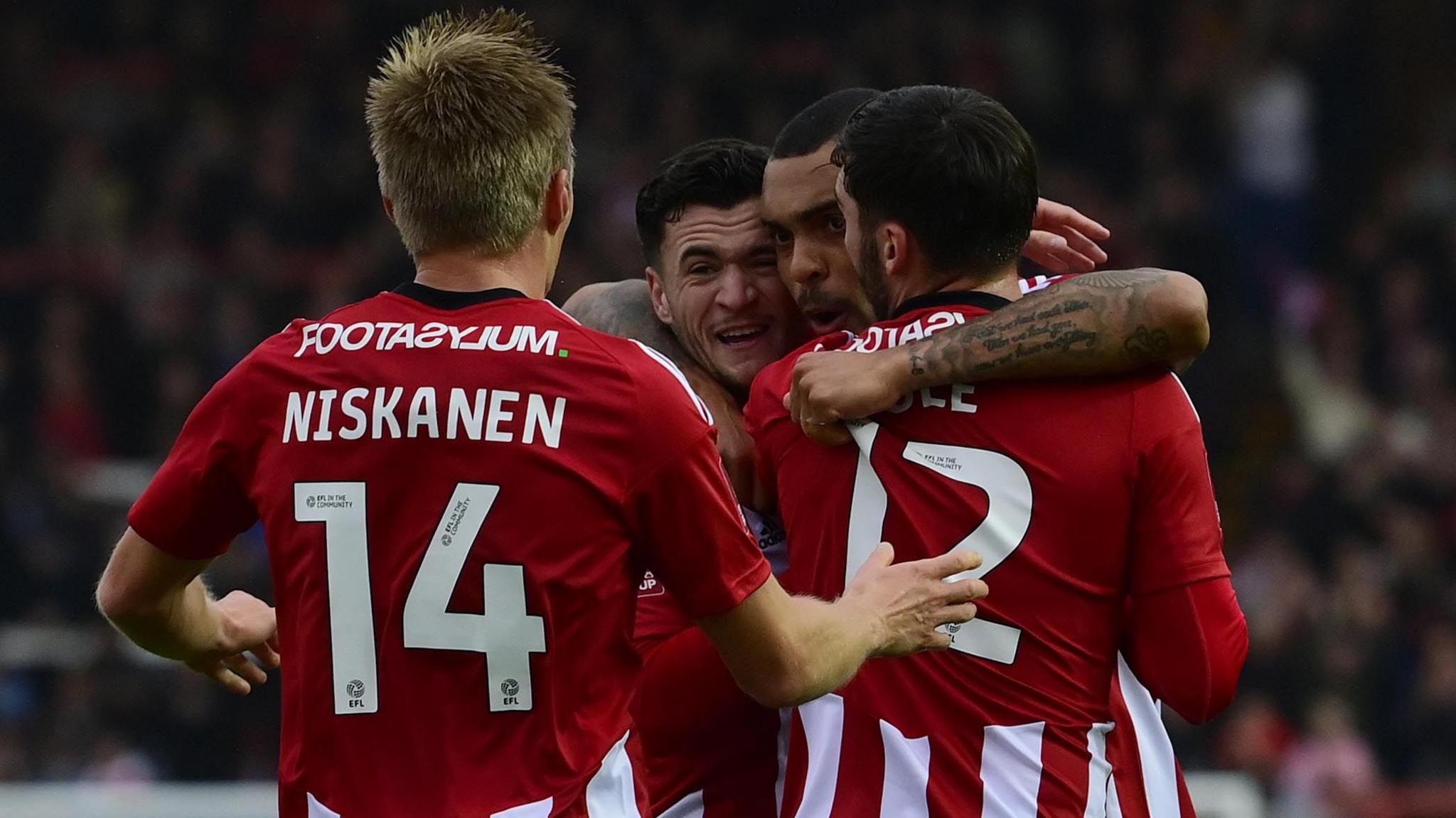 Exeter City players celebrate a goal