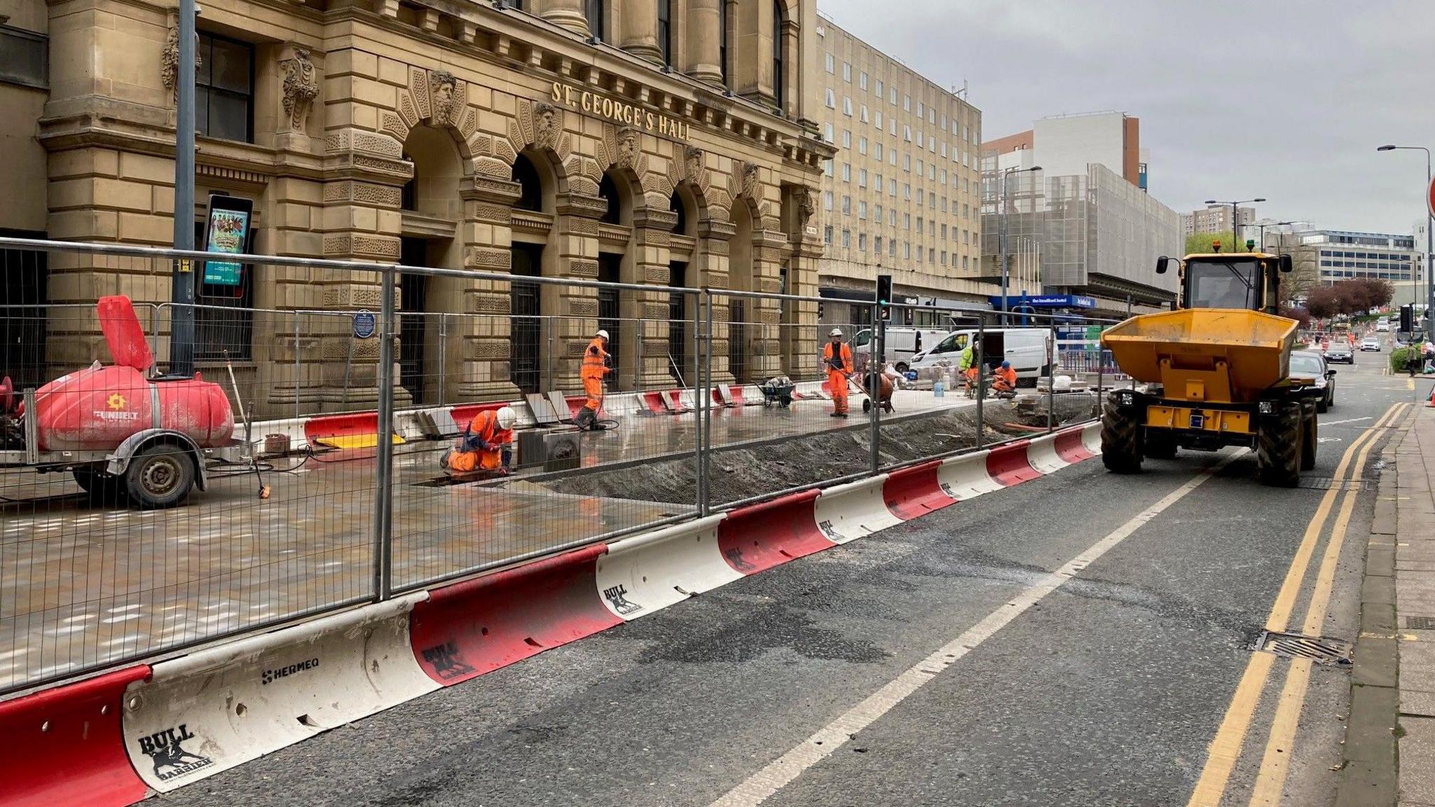 A dumper truck drives down Hall Ings in Bradford