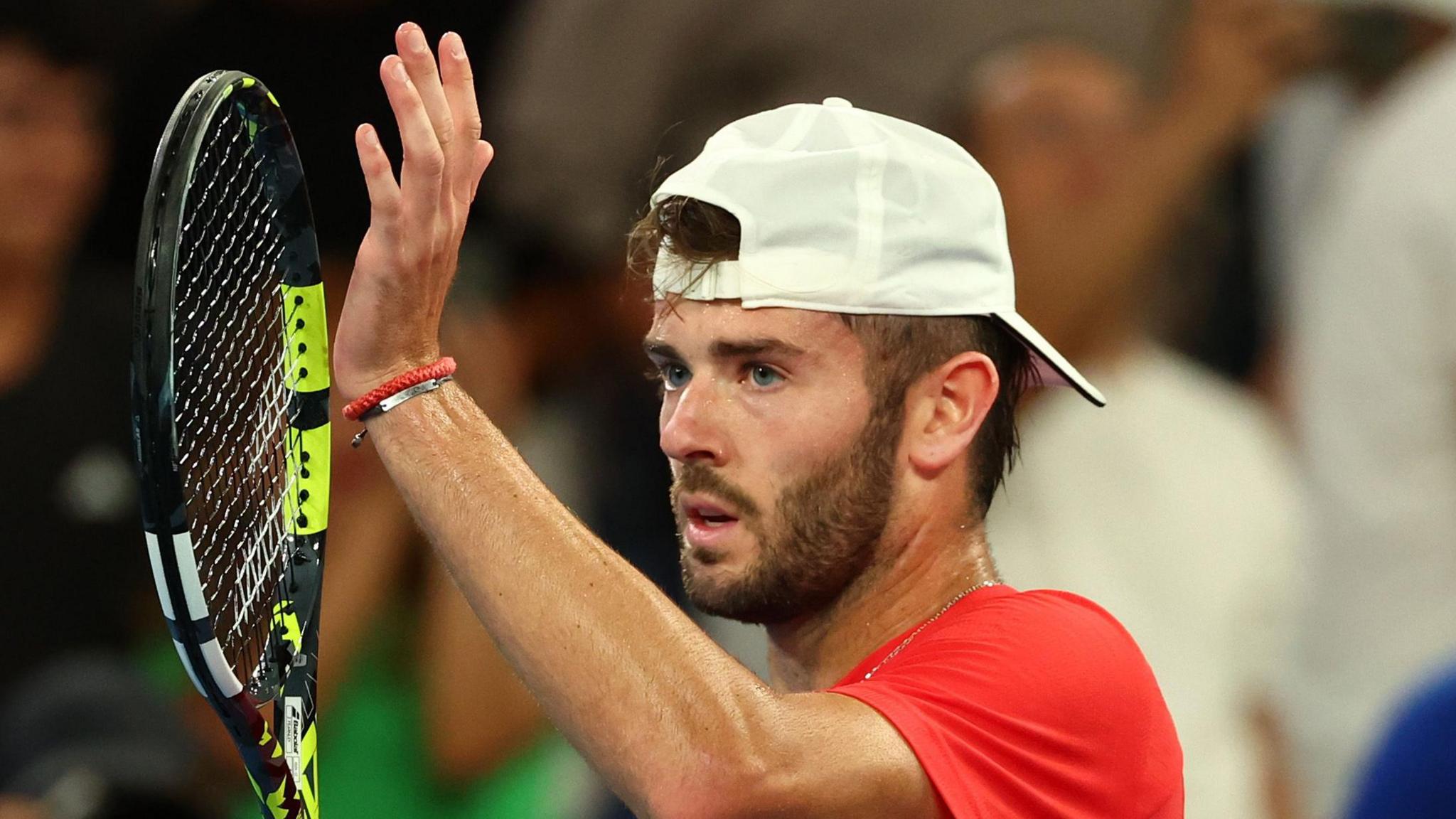 Jacob Fearnley claps his racquet after beating Nick Kyrgios at the Australian Open