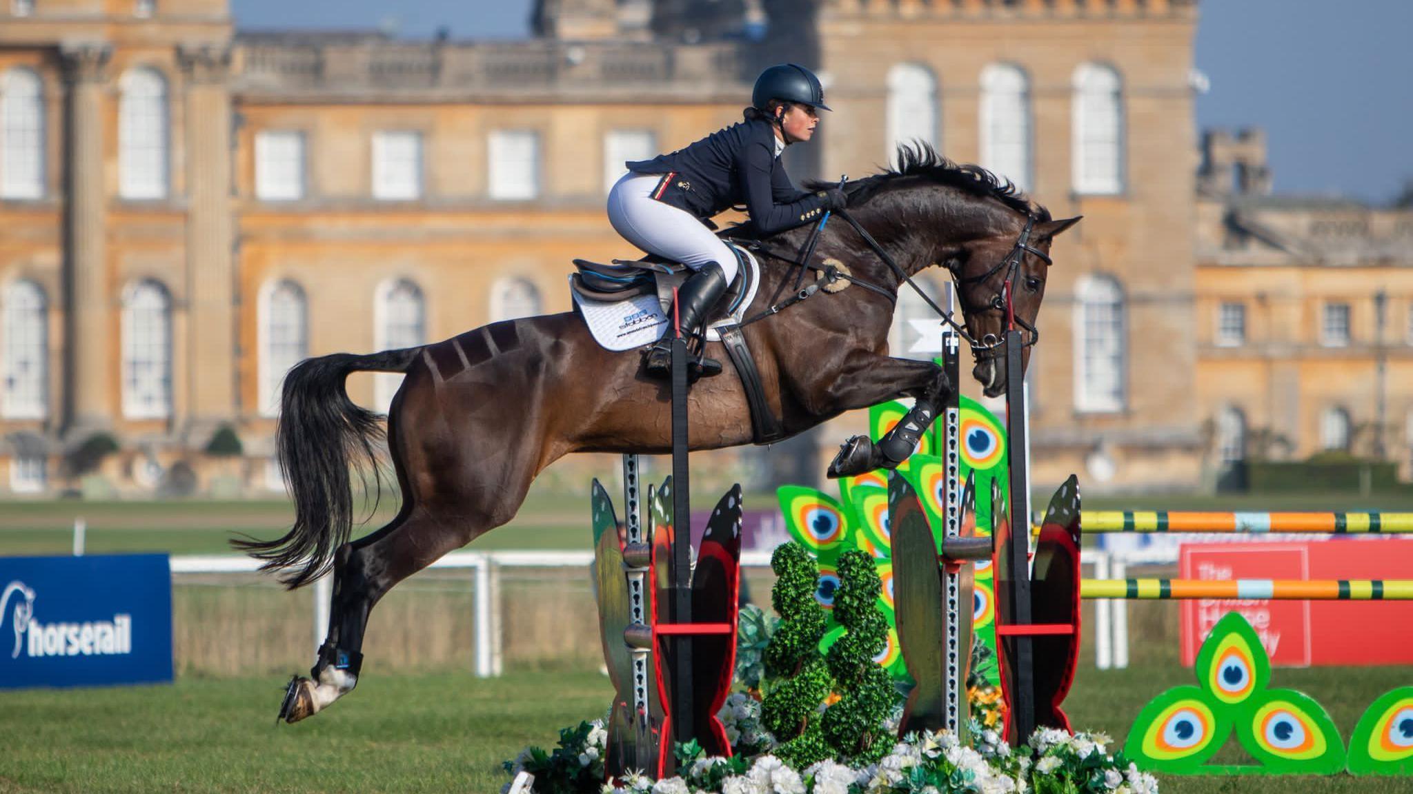 Saffron Cresswell riding a horse at an event