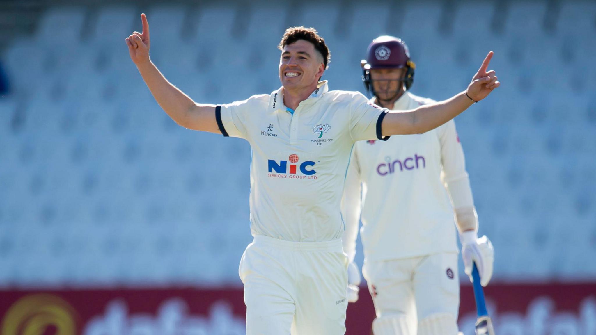 Matthew Fisher celebrates taking a wicket for Yorkshire