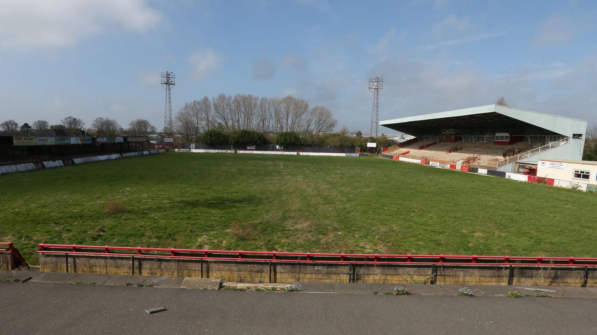 A derelict Rockingham Road as seen in 2013. The pitch has become visibly overgrown and the stadium appears in a poor general state of repair.