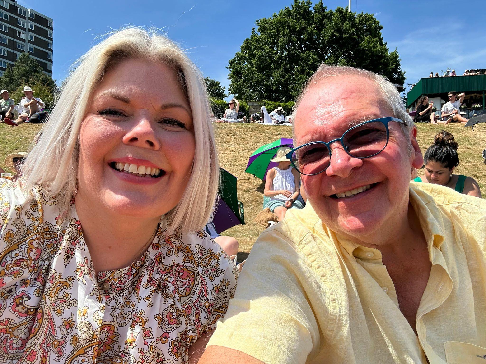 Fan Nigel is sitting on Henman Hill taking a selfie with his wife Caroline 