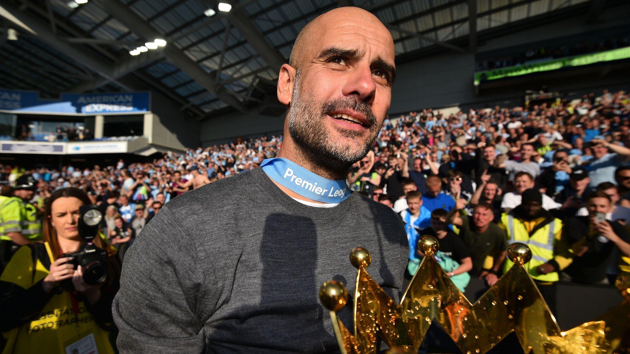 Manchester City boss Pep Guardiola holds the Premier League trophy