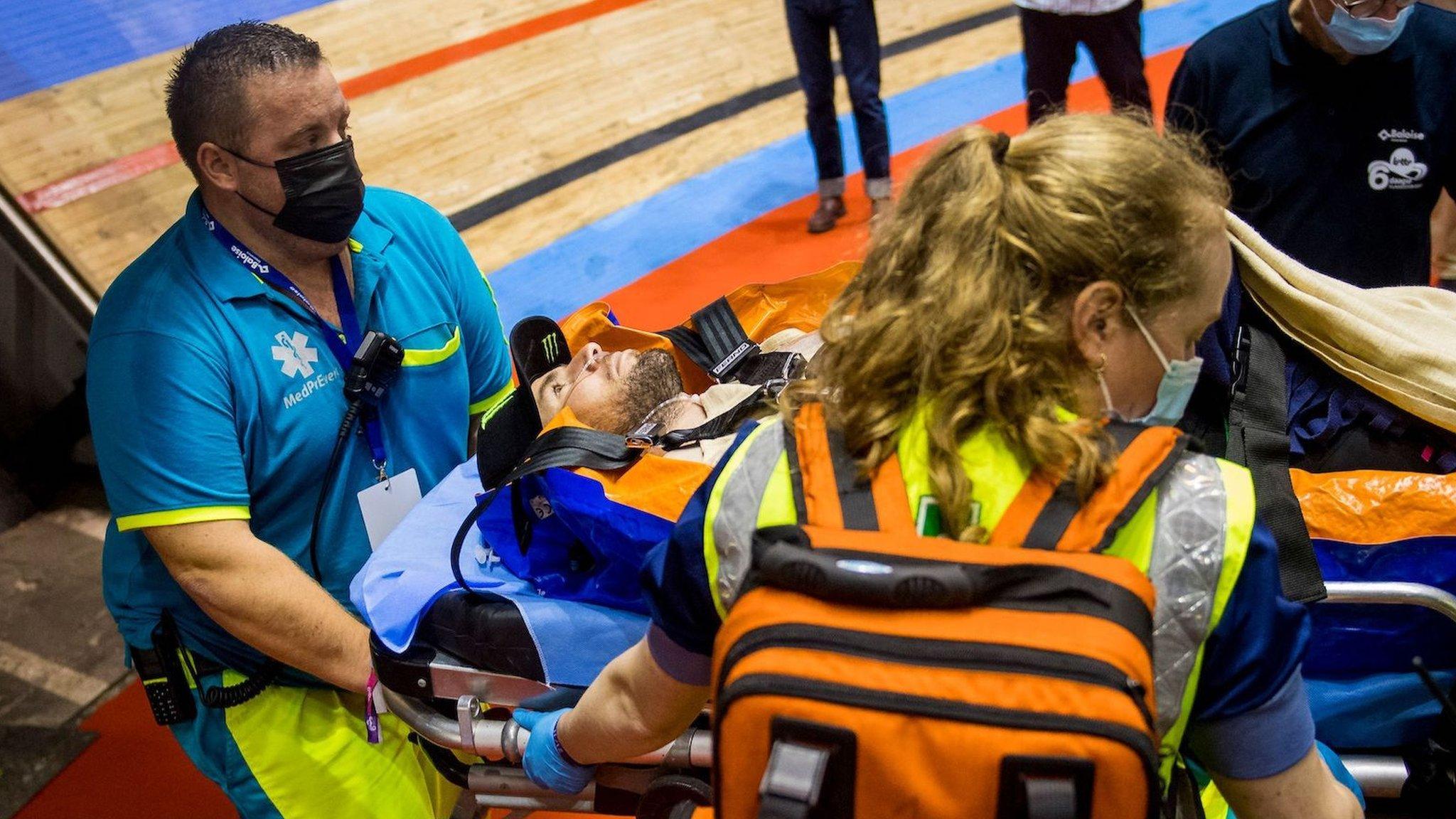 Mark Cavendish is carried away on a stretcher