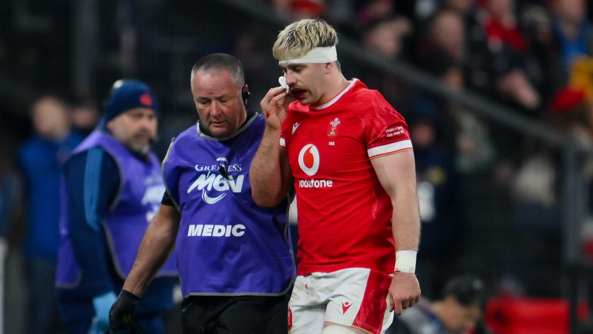 Wales number eight Aaron Wainwright leaves the field due to injury