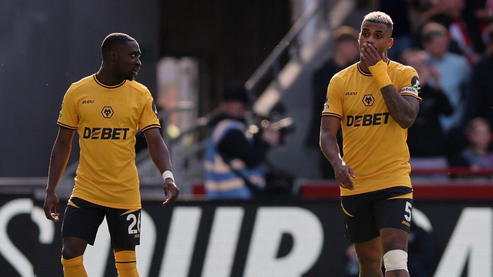 Wolves' Carlos Forbs (left) and Mario Lemina react to conceding another goal in the defeat at Brentford