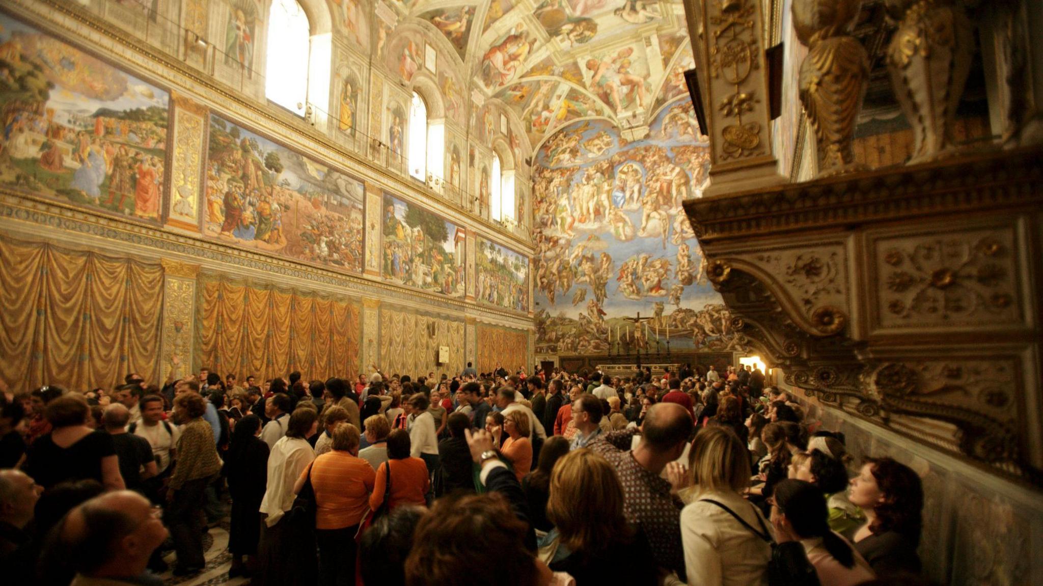 A crowd pictured touring the Sistine Chapel in the Vatican.