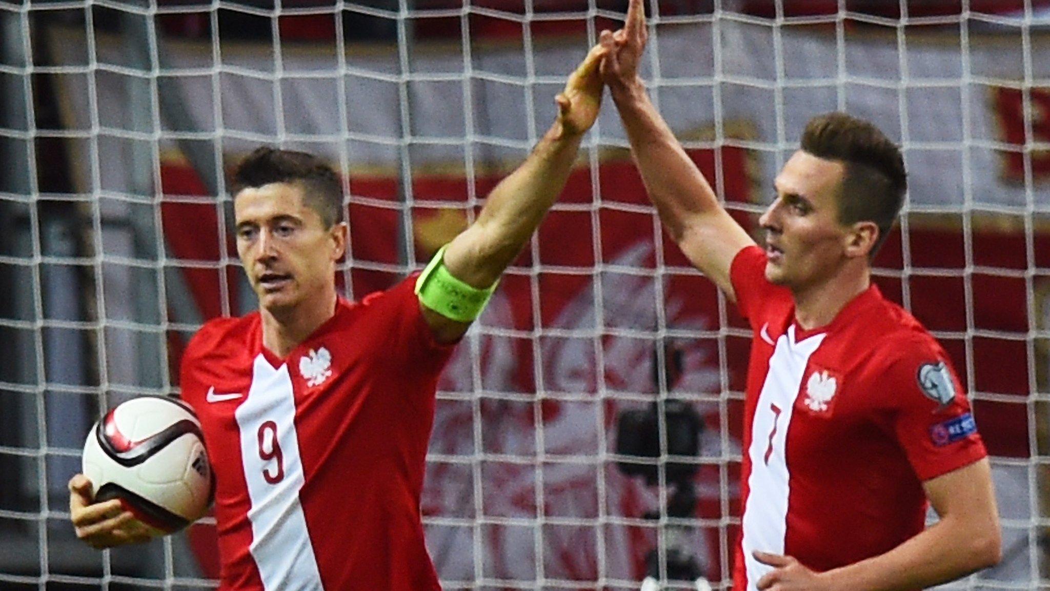 Poland's Robert Lewandowski and Arkadiusz Milik celebrate