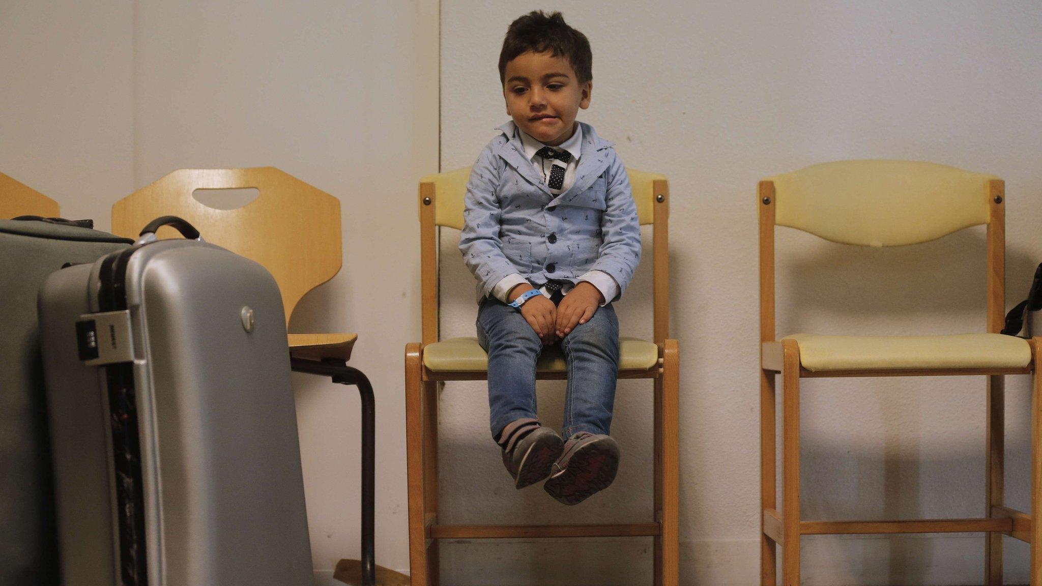 Syrian refugee with suitcase