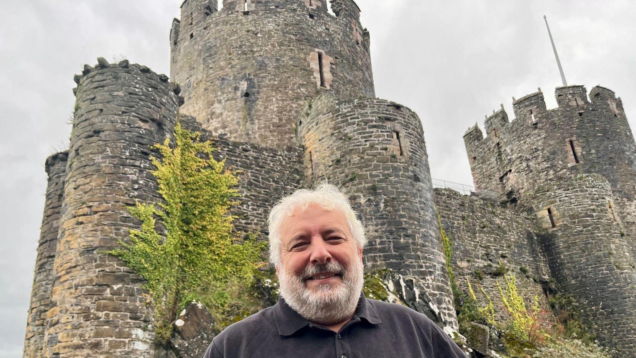 Head of Cadw Gwilym Hughes pictured in front of the real Conwy Castle.