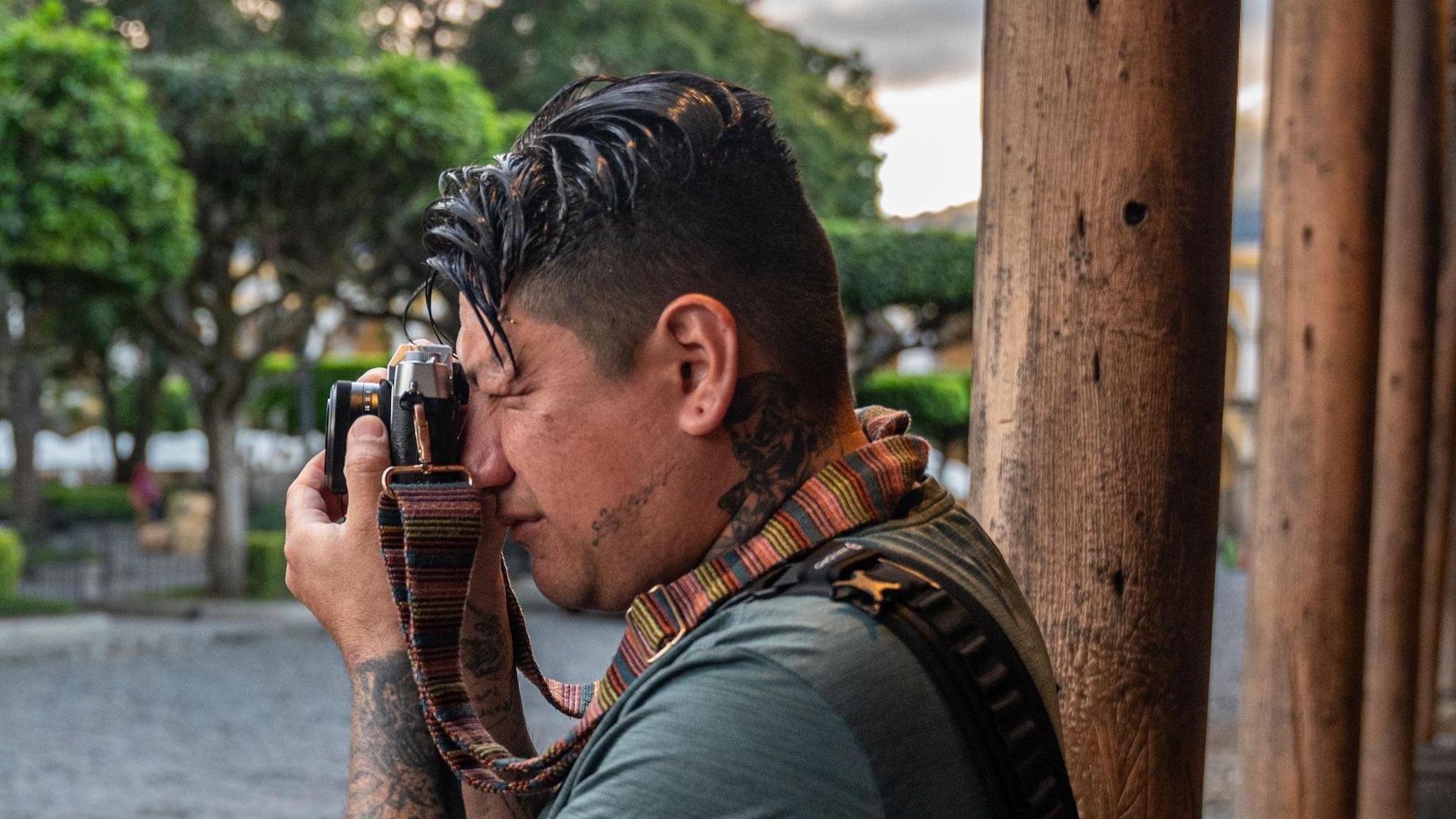 Steven López looks through the viewfinder of his analogue camera in Antigua, Guatemala.