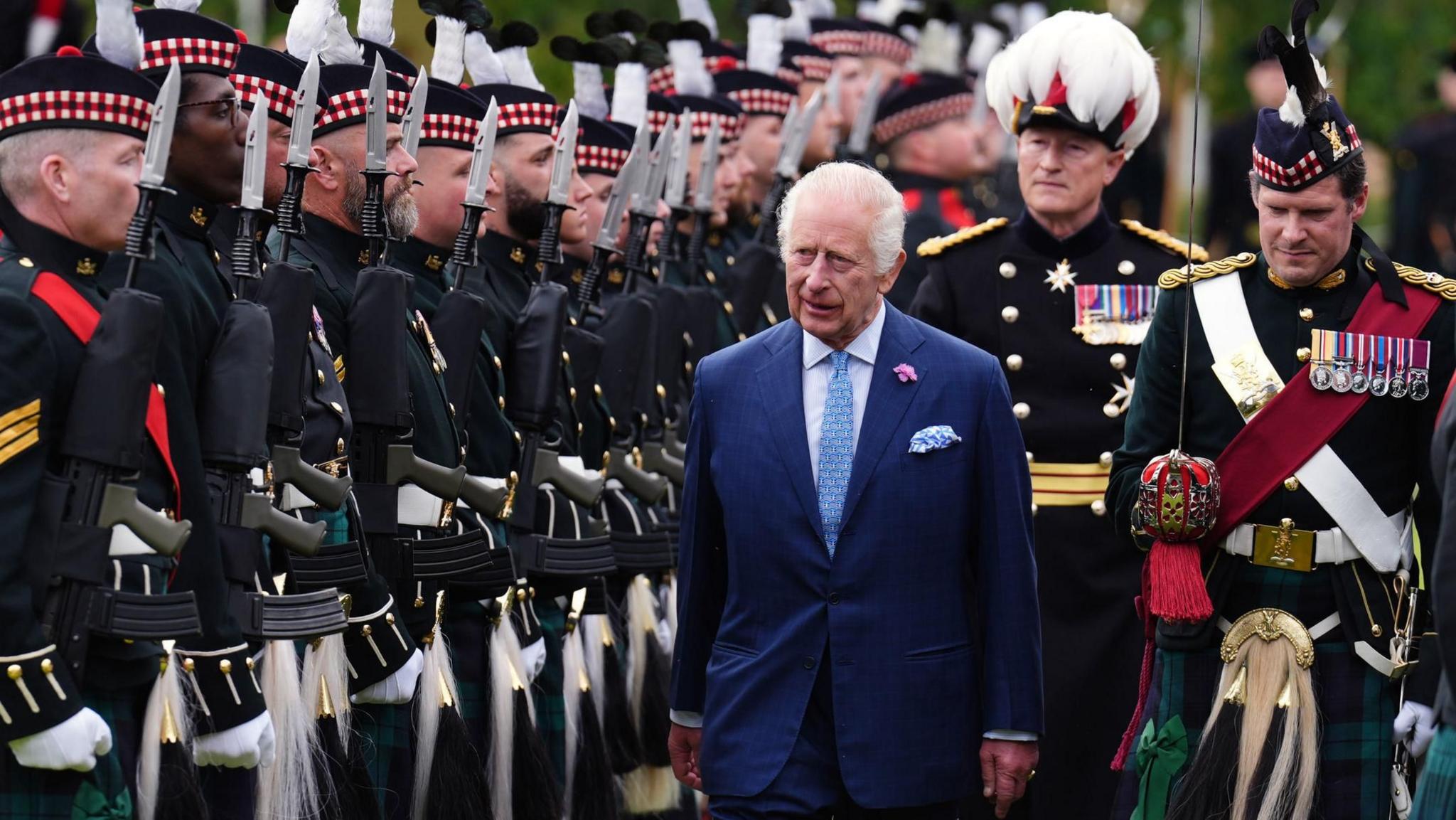 The King inspects a guard of honour in the Palace of Holyroodhouse garden