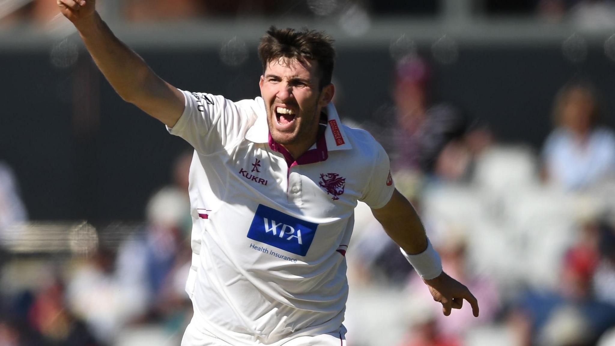 Craig Overton with arm aloft to celebrate taking a Lancashire wicket