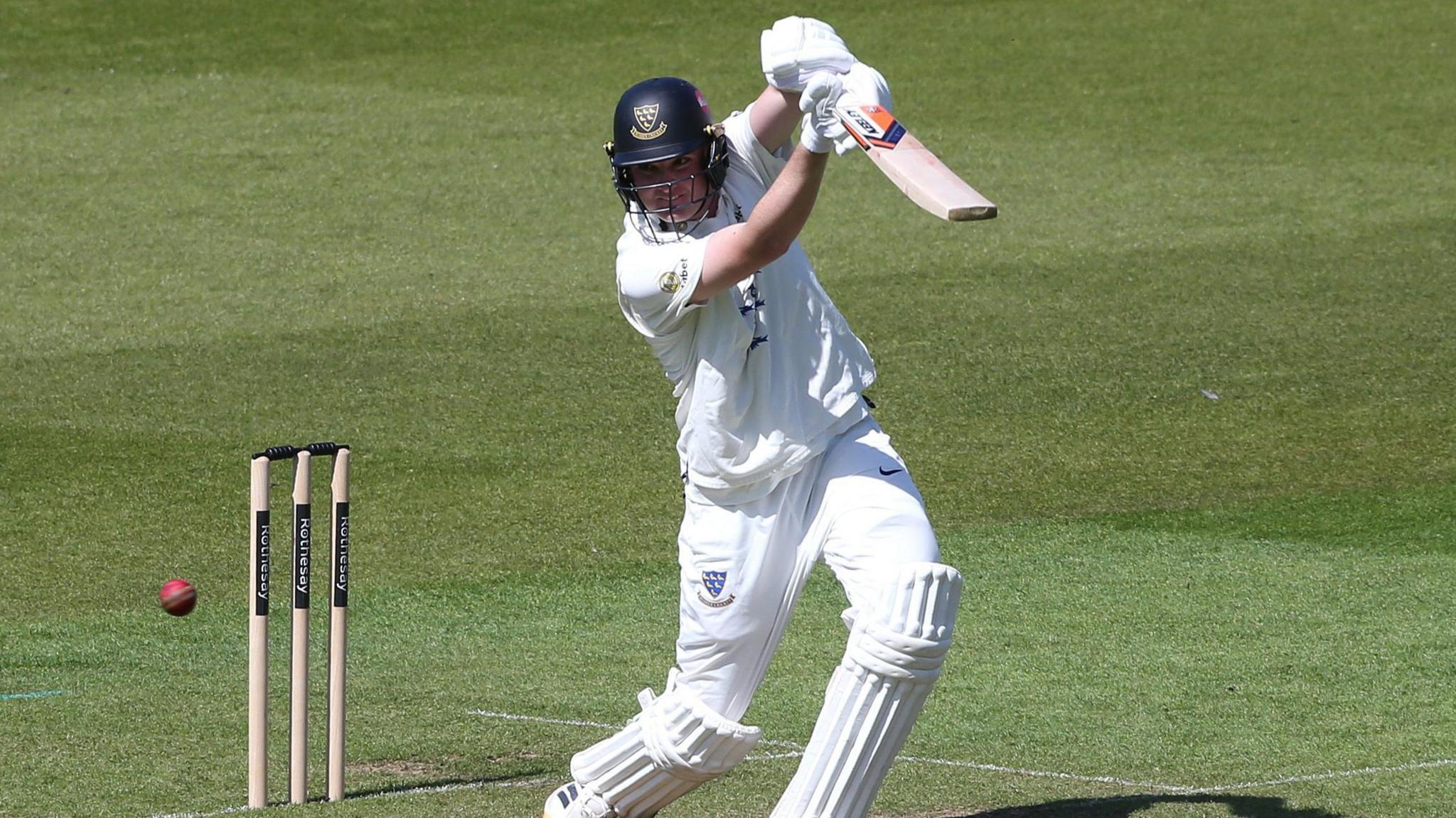 Jack Carson drives for Sussex against Surrey