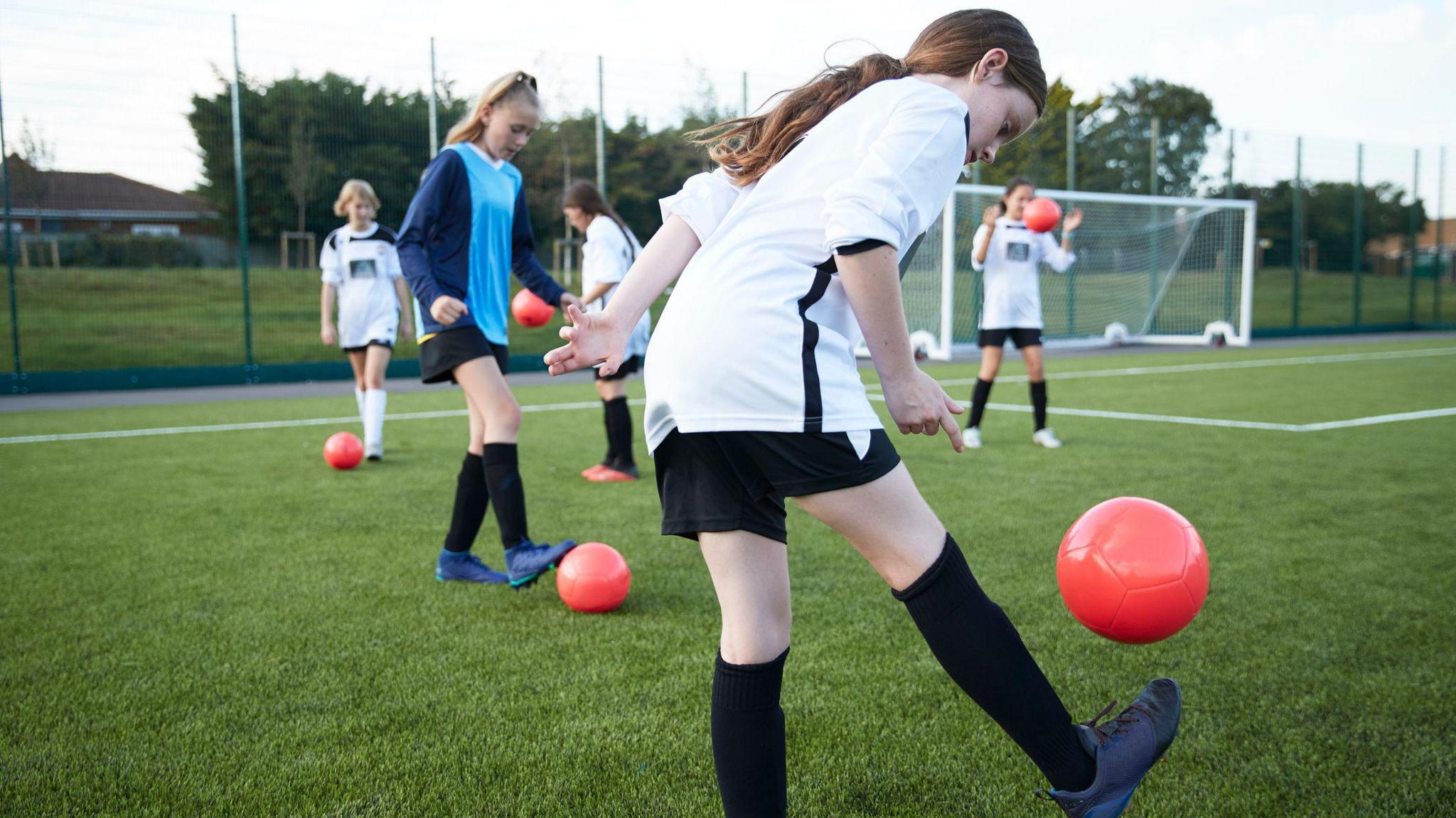 A group of girls playing football