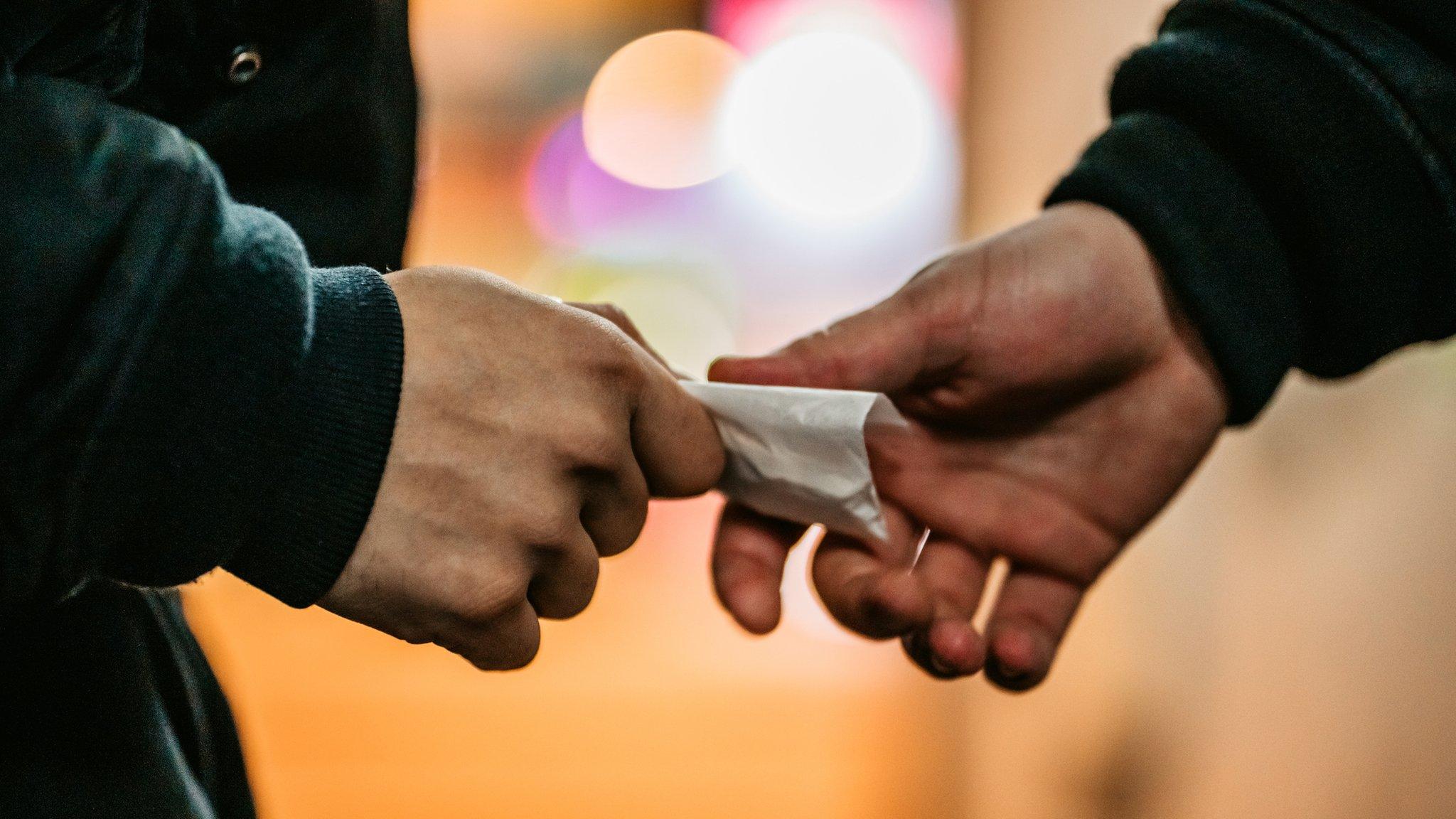 Men exchanging drugs