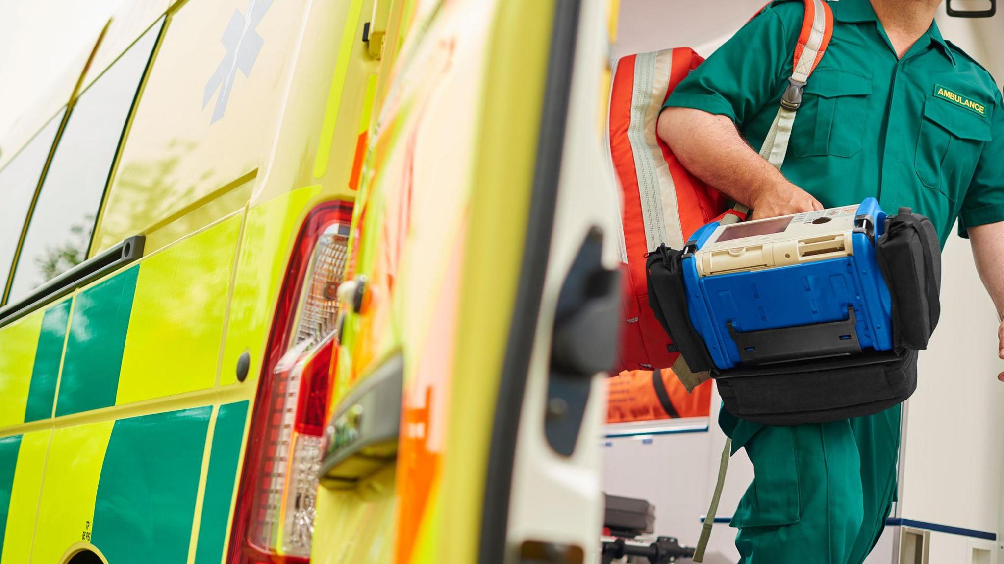 An ambulance worker stepping out the back of an ambulance