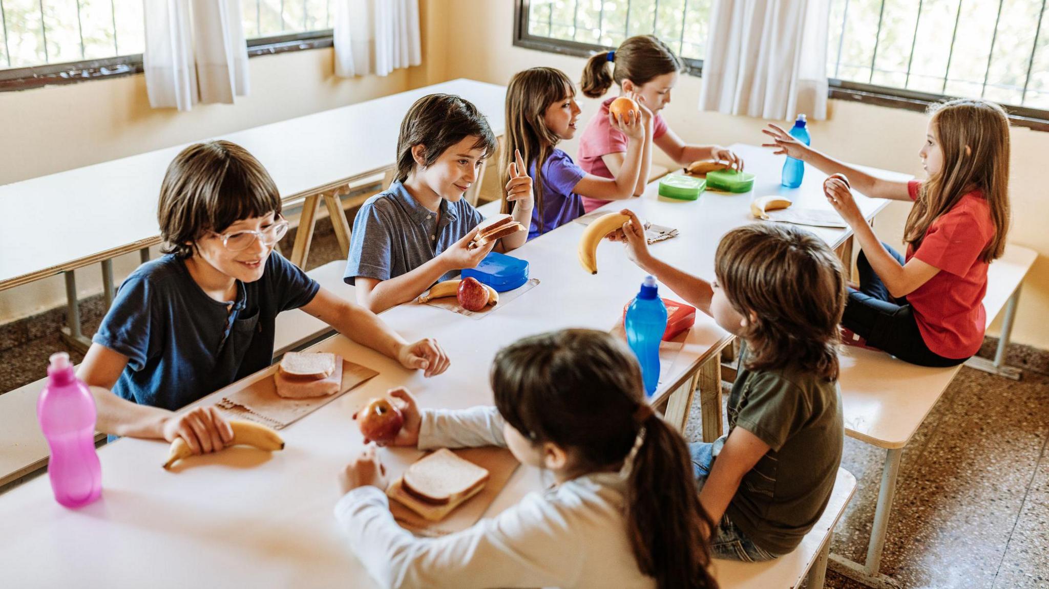 Children sat around a table at a breakfast club