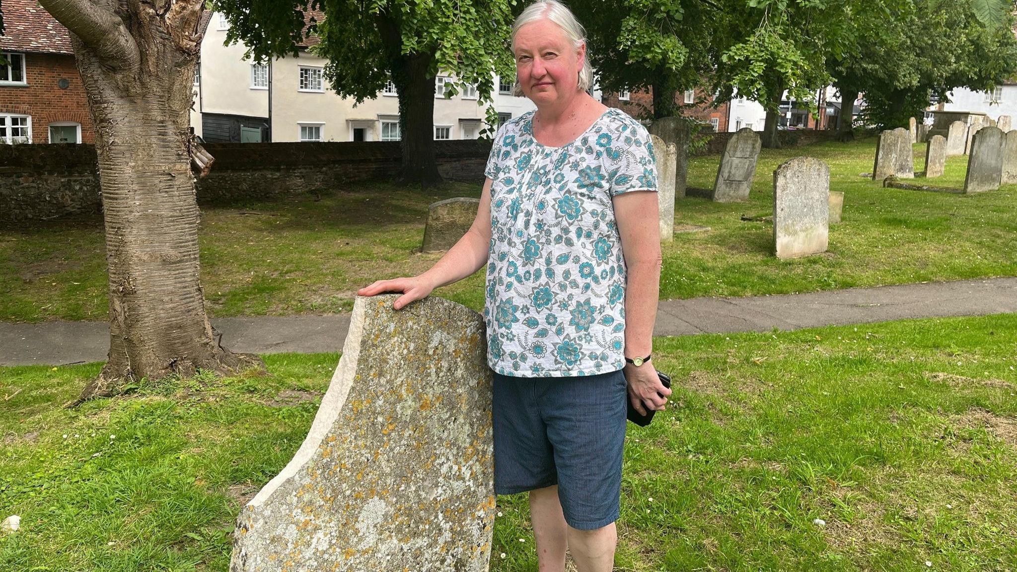 woman in front of vandalism