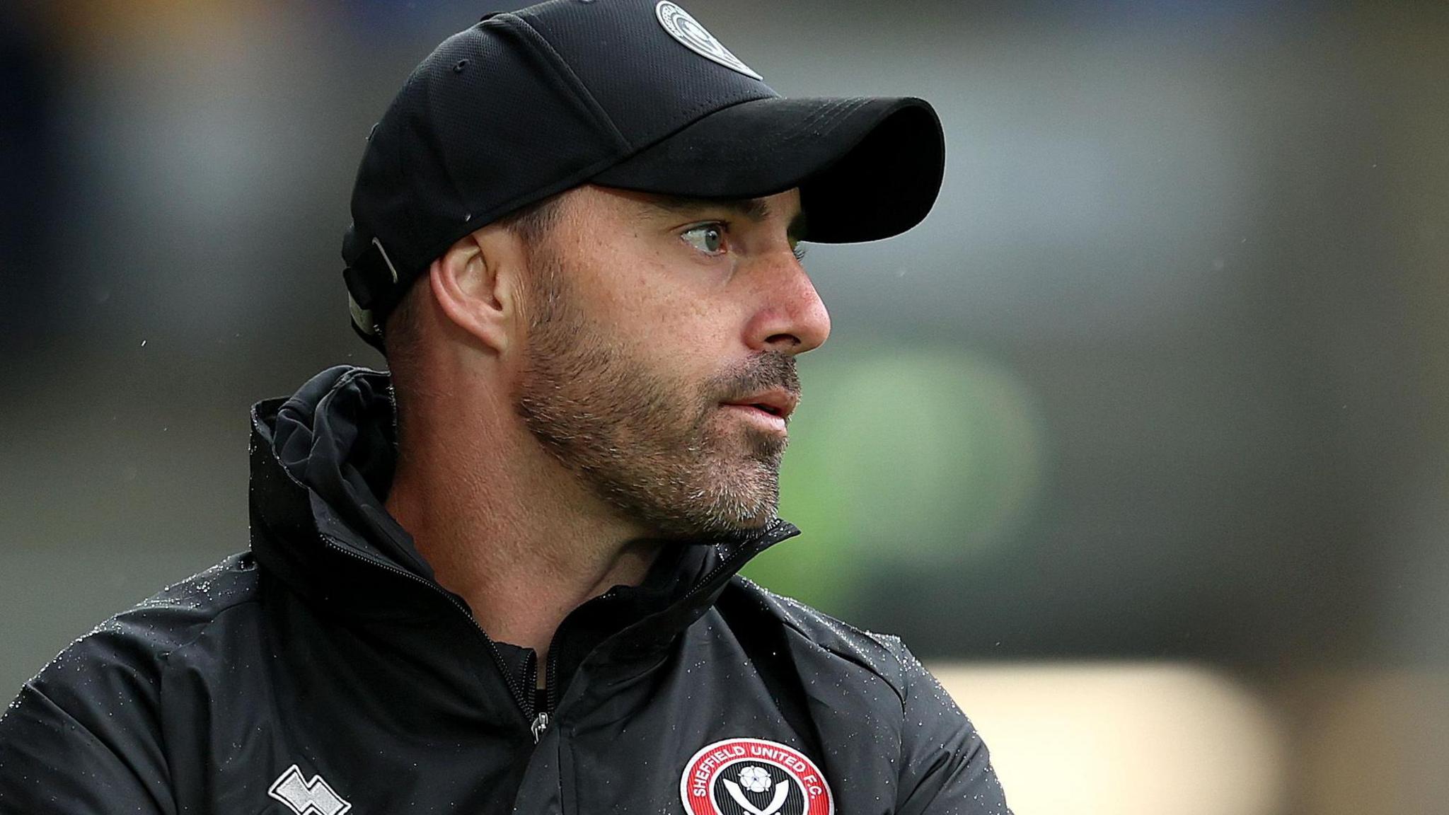 Ruben Selles wearing a Sheffield United jacket and cap