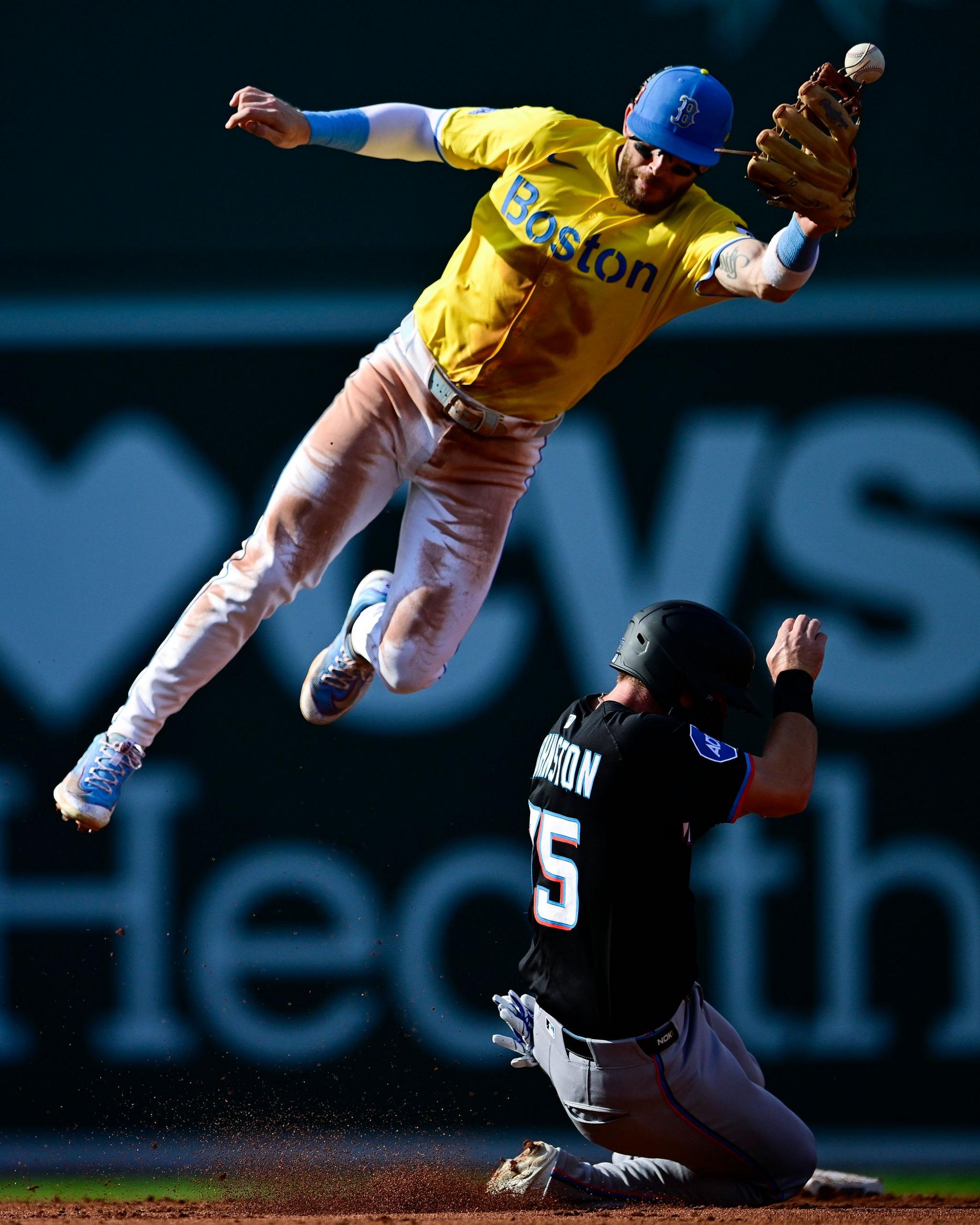 Miami Marlins' Troy Johnston slides safely into second base against Boston Red Sox's Trevor Story in the third inning at Fenway Park in Boston, Massachusetts. Photo by Jaiden Tripi