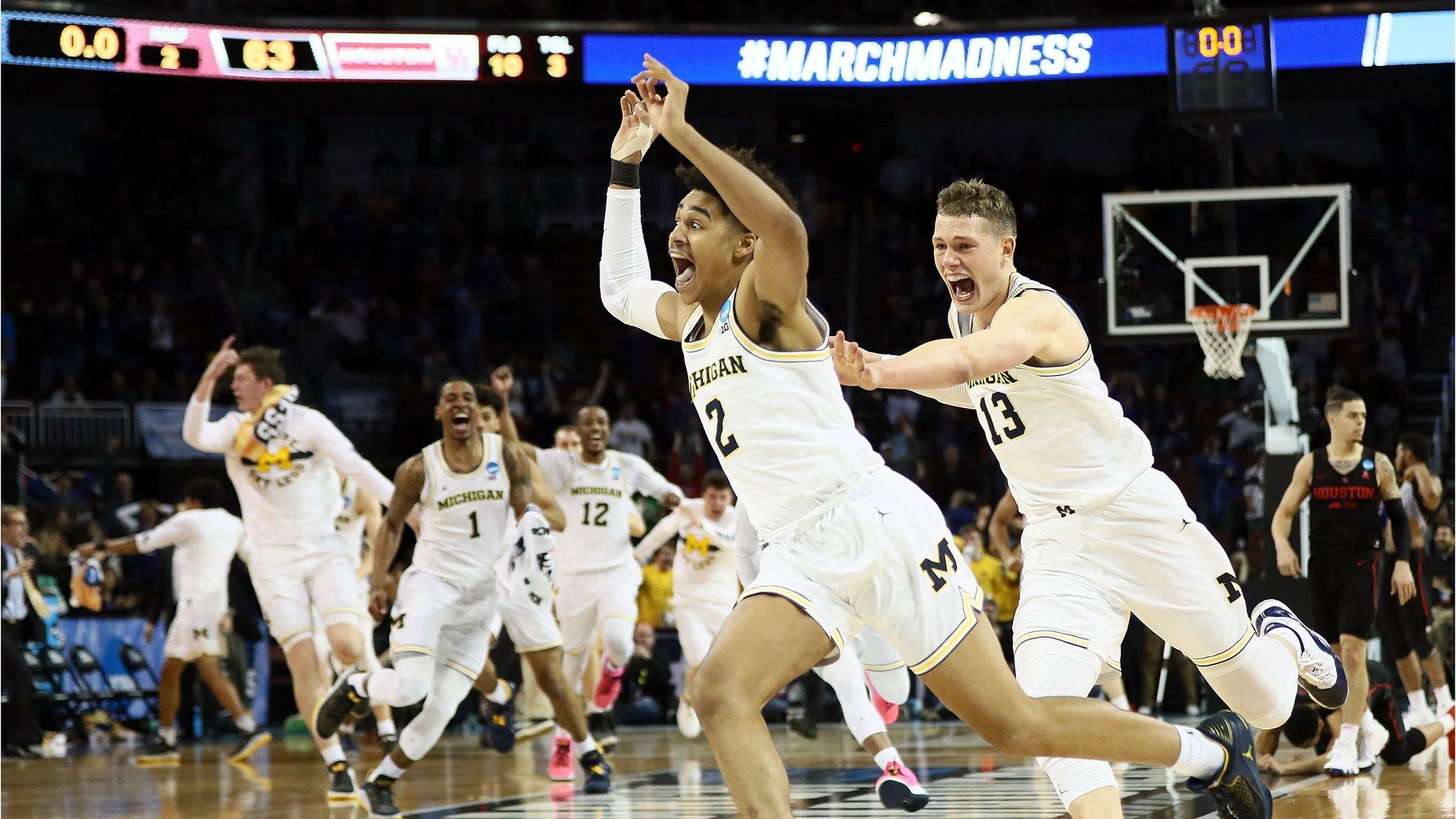 Jordan Poole #2 and Moritz Wagner #13 of the Michigan Wolverines celebrate Poole's 3-point buzzer beater for a 64-63 win over the Houston Cougars during the second round of the 2018 NCAA Men's Basketball Tournament at INTRUST Bank Arena on March 17, 2018