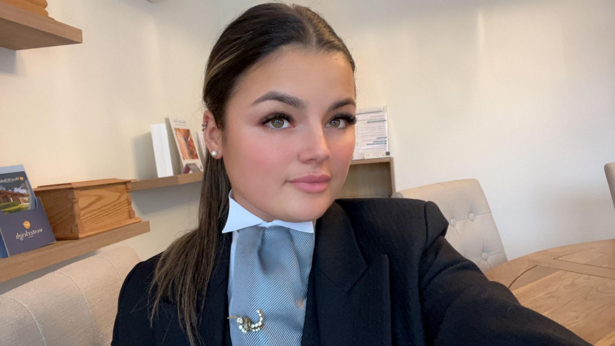 A selfie of a young woman dressed in black funeral attire