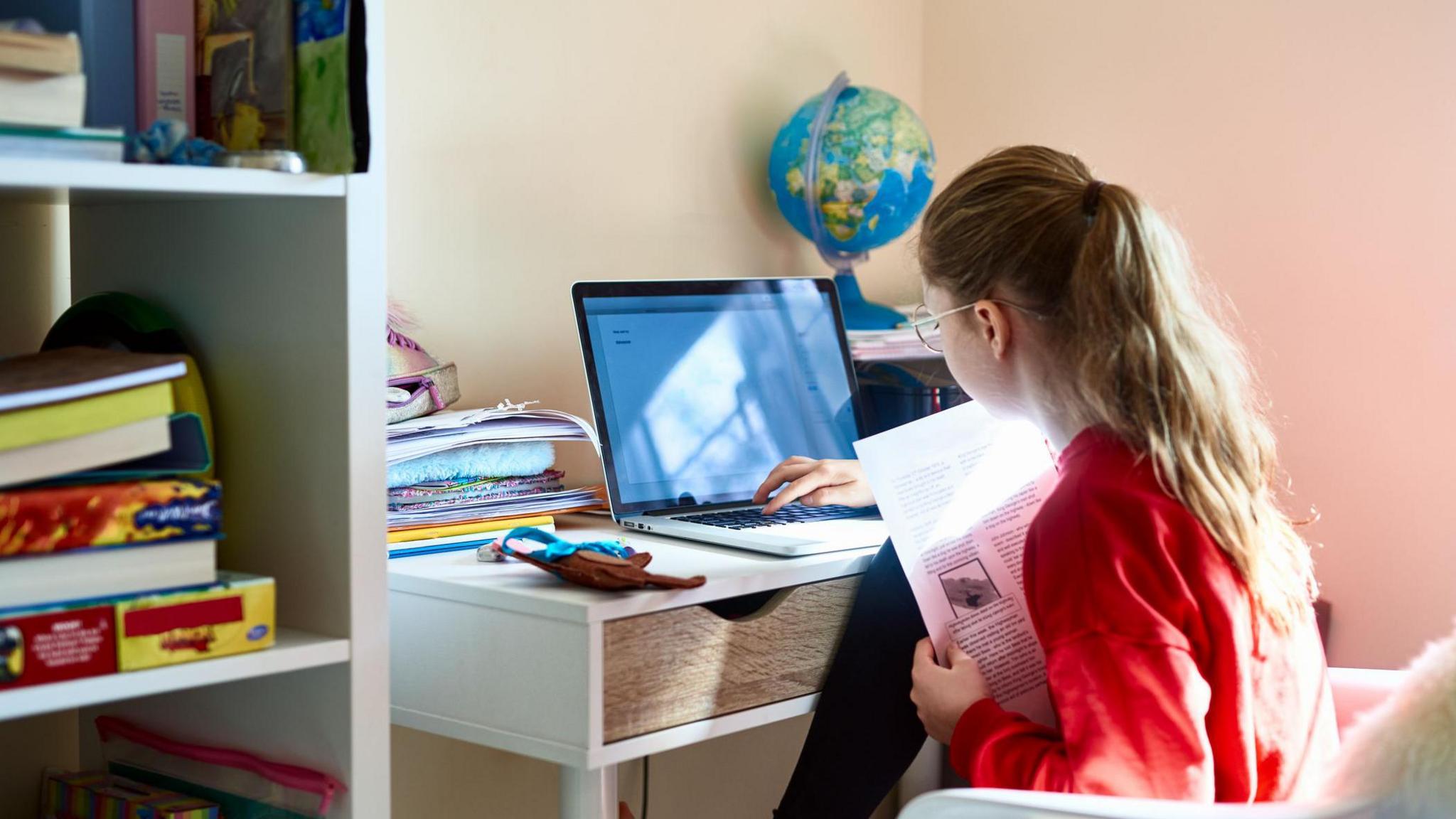 Girl sat at her laptop