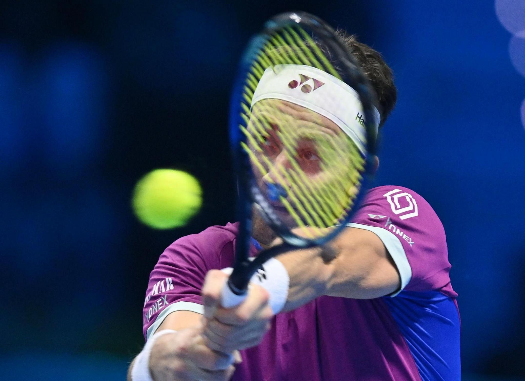 Tennis player Casper Ruud of Norway is seen with the tennis racket in front of his face as he prepares to strike the ball