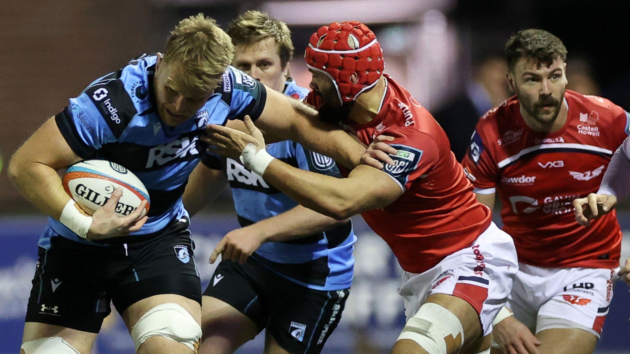 Josh McNally of Cardiff is tackled by Josh Macleod of Scarlets