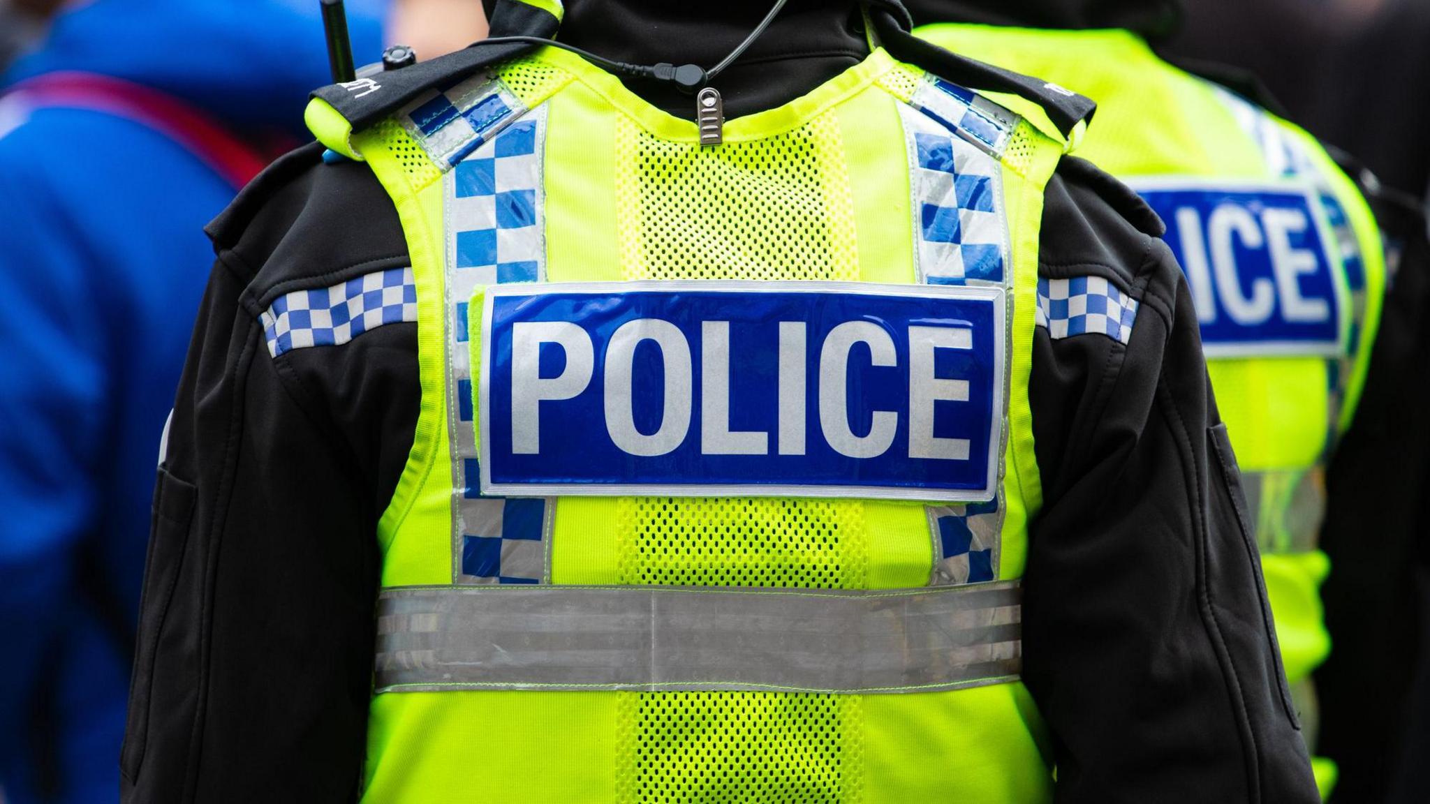 A generic shot of the back of a police officers jacket. 